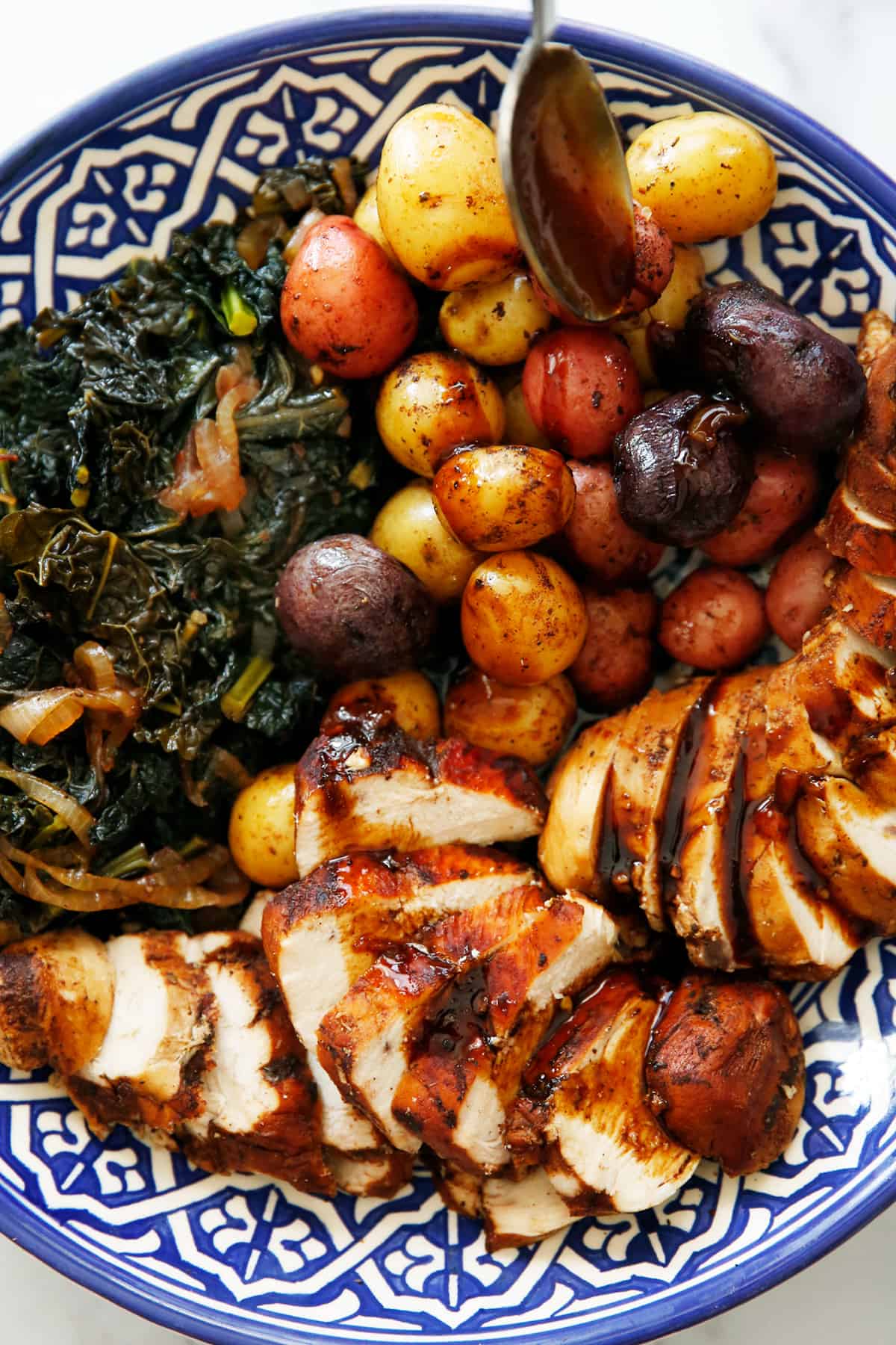 Instant Pot Balsamic Chicken on a platter with kale and potatoes.