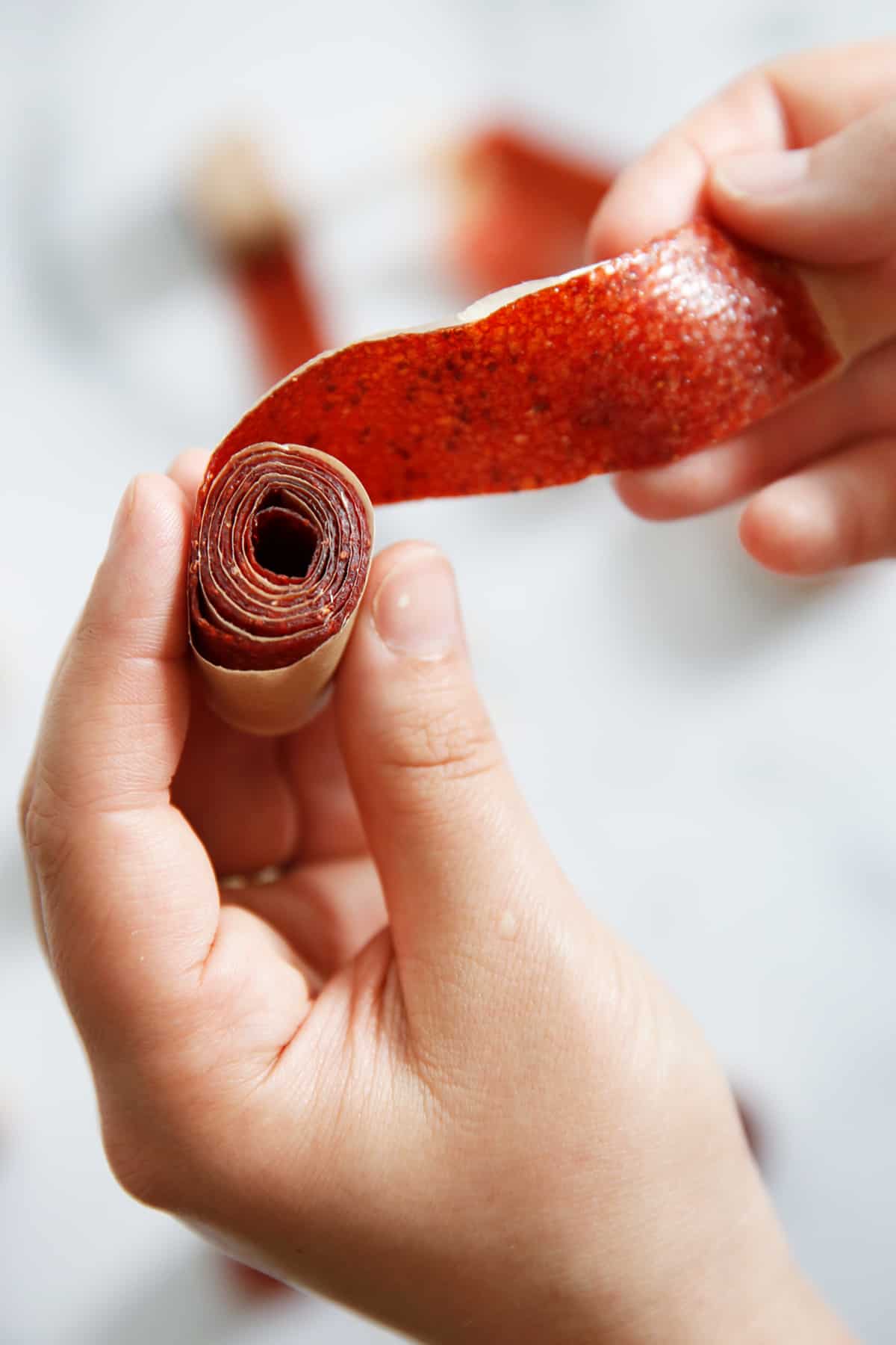 Strawberry fruit leather rolled up like a fruit rollup