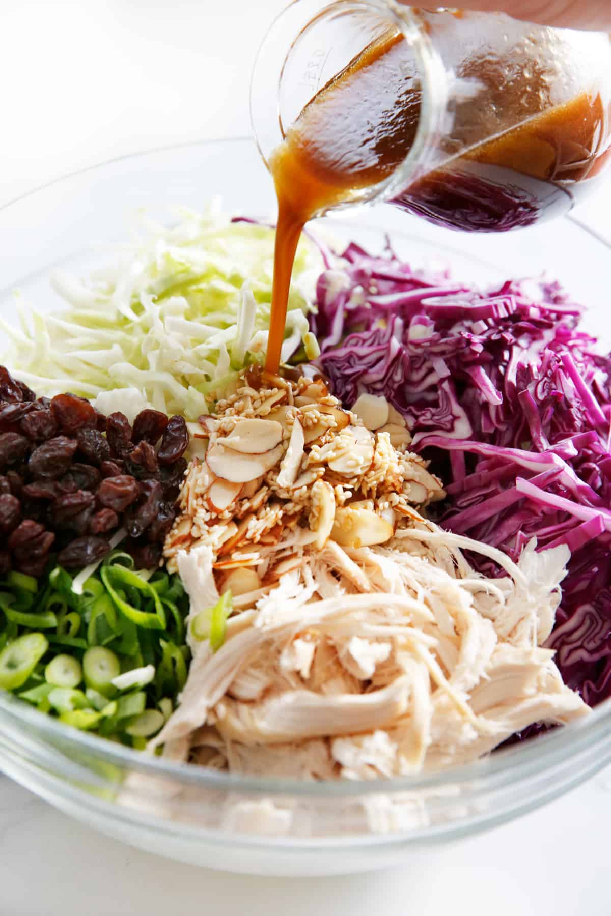 sweet sesame dressing poured over chicken Thai slaw