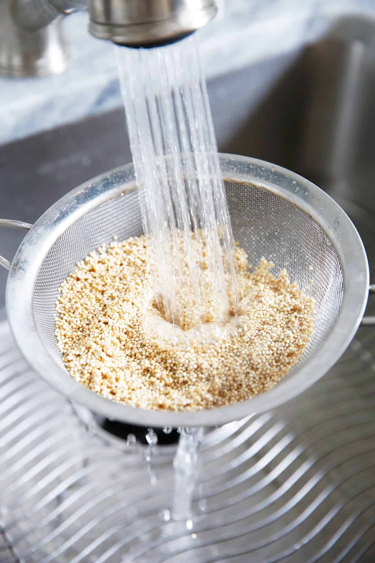 Rinse quinoa in the sink