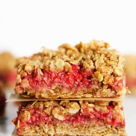 Two raspberry oatmeal bars stacked up on each other.