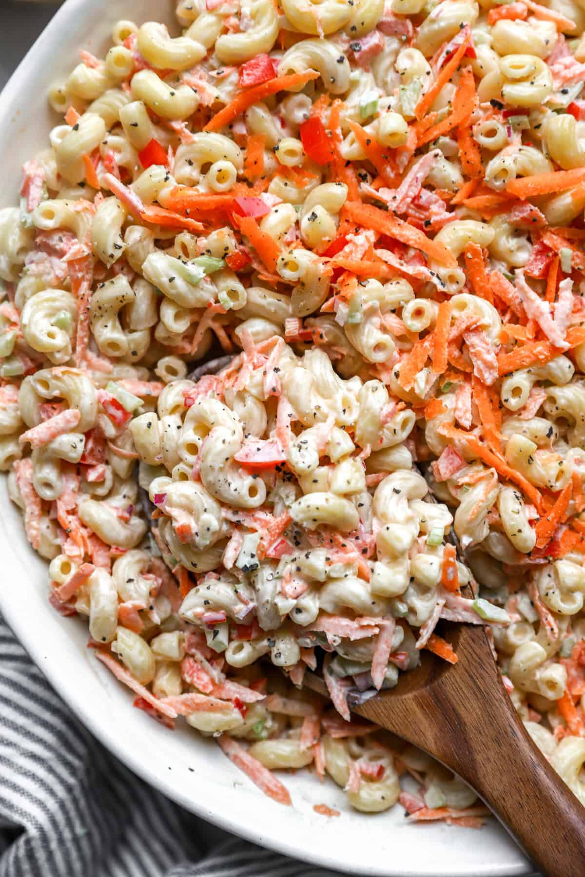 above and closeup of classic macaroni salad in a serving bowl.