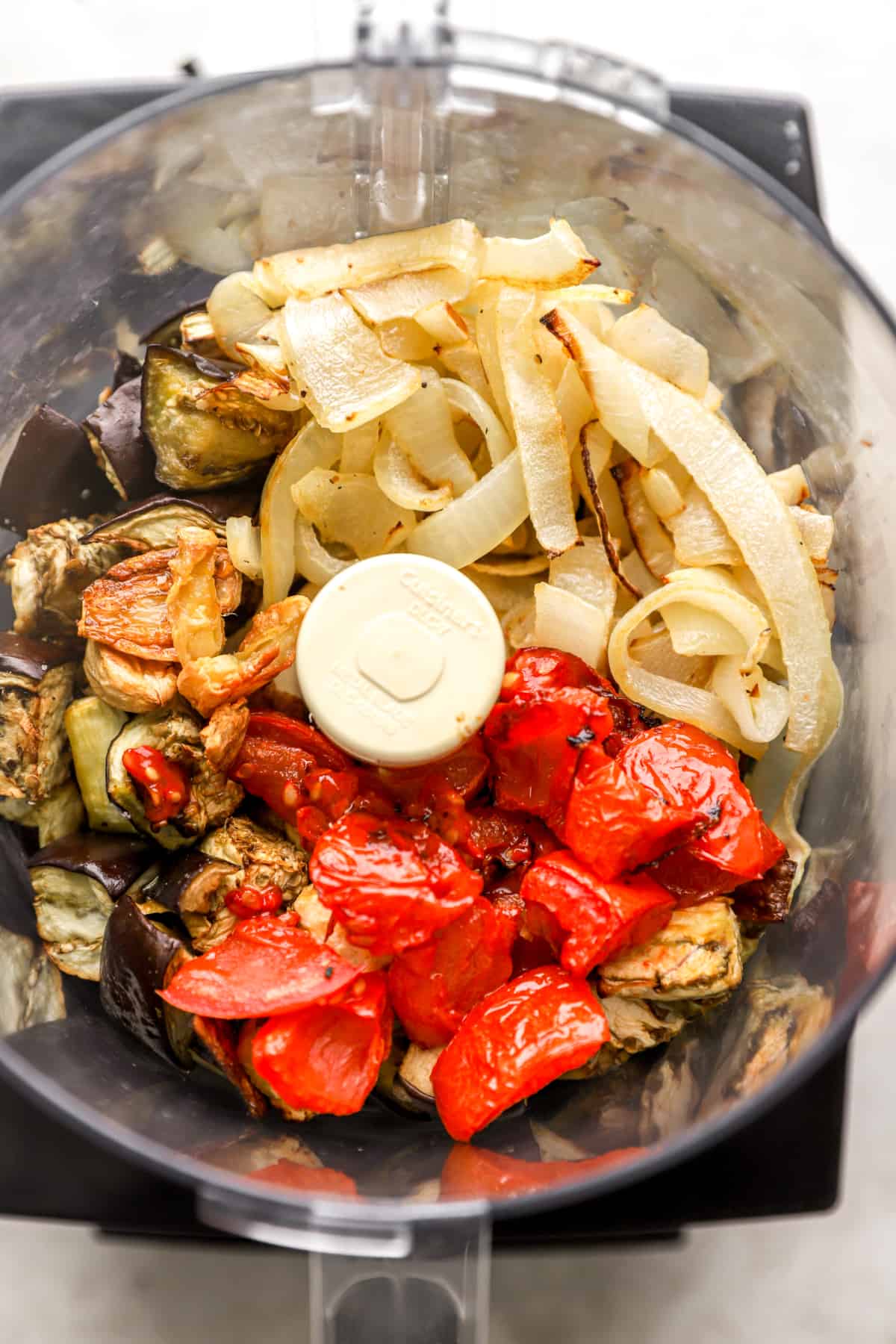 Roast tomatoes, onions, eggplant and garlic in food processor.