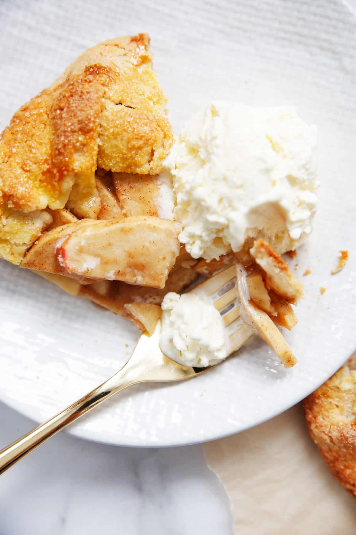 A slice of Apple Galette with ice cream on a plate