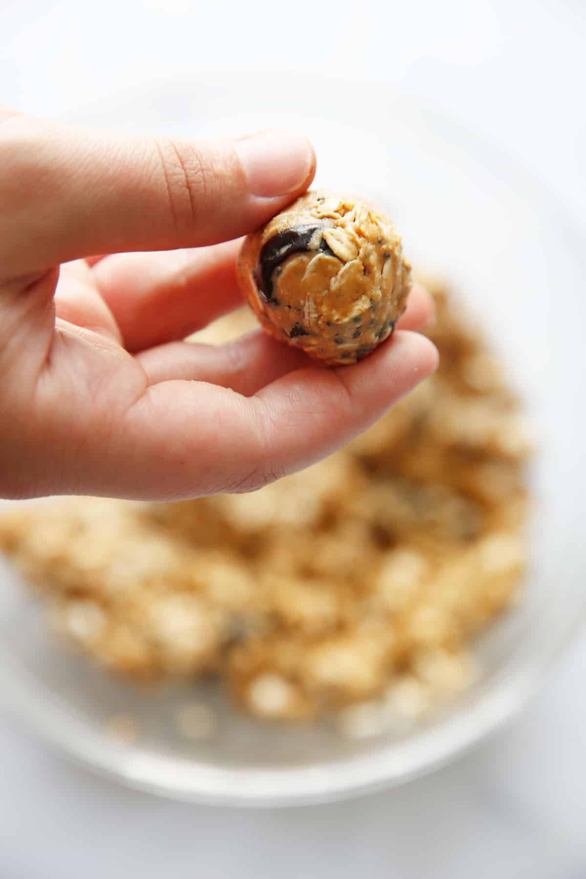 no bake peanut butter oatmeal balls being rolled up