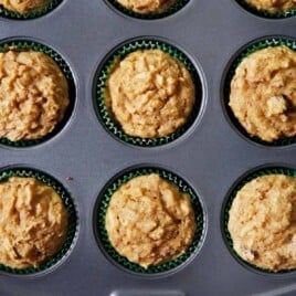 Gluten free apple muffins in a muffin tin.