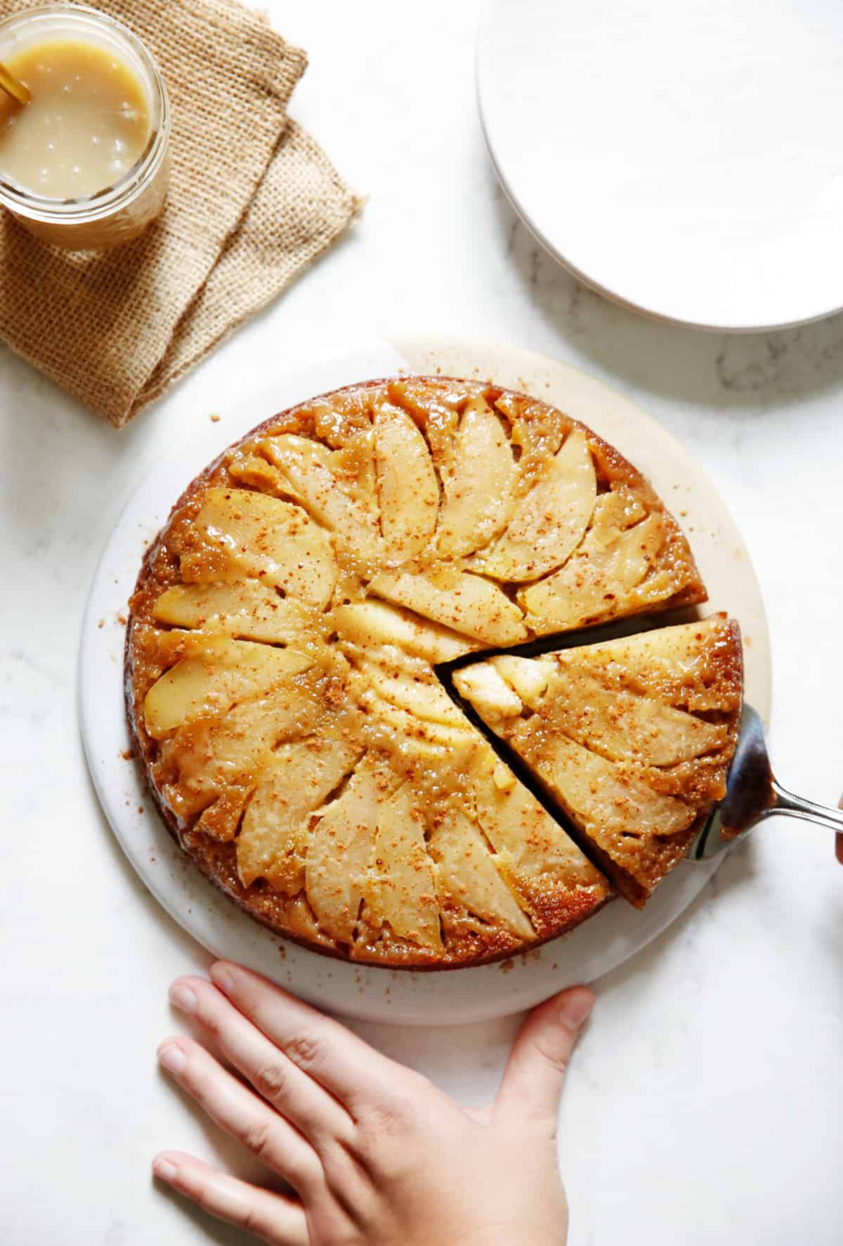 Gluten free apple cake with a slice taken from it