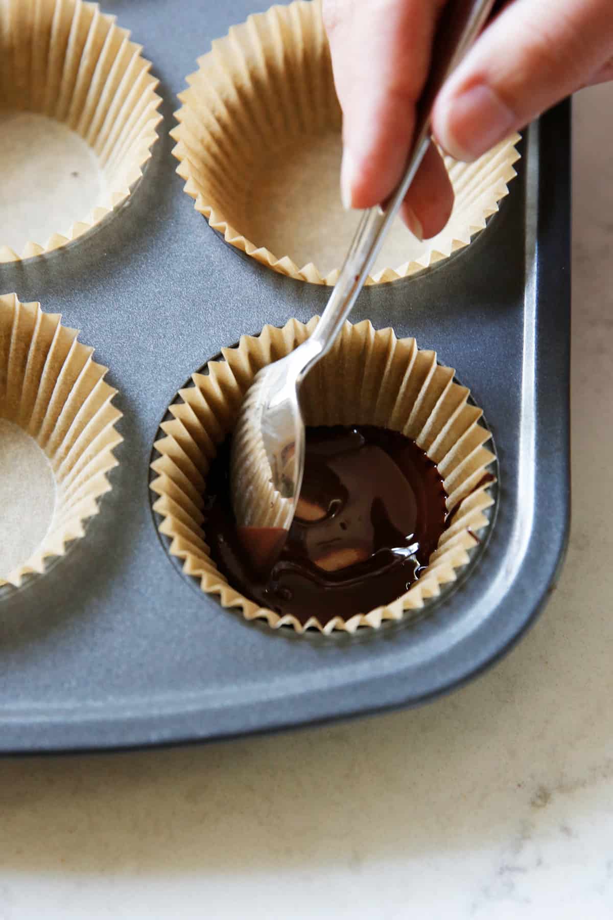 Placing chocolate on pumpkin cups