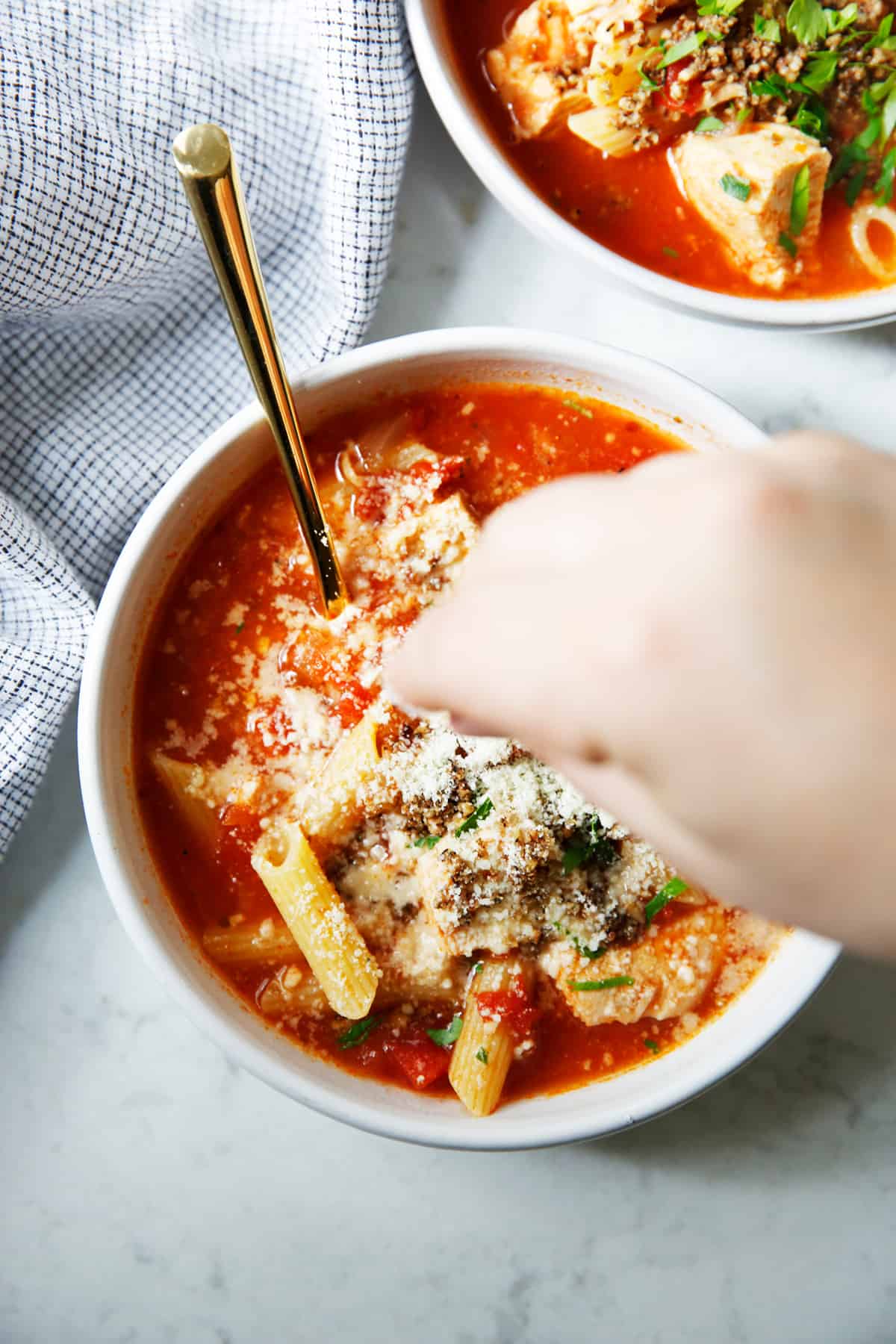 Sprinkling Parm on chicken Parm soup