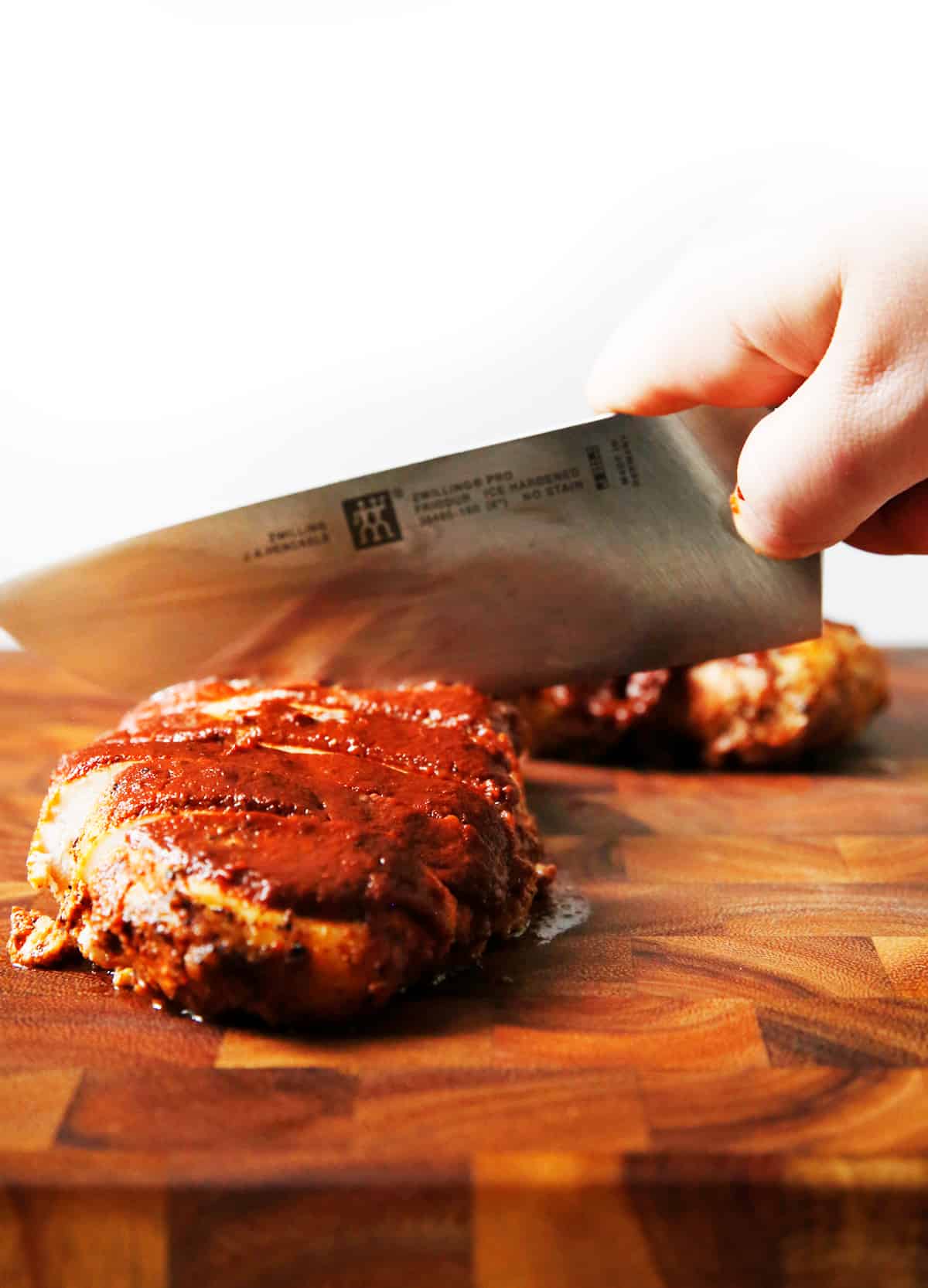 Slicing into baked bbq chicken 