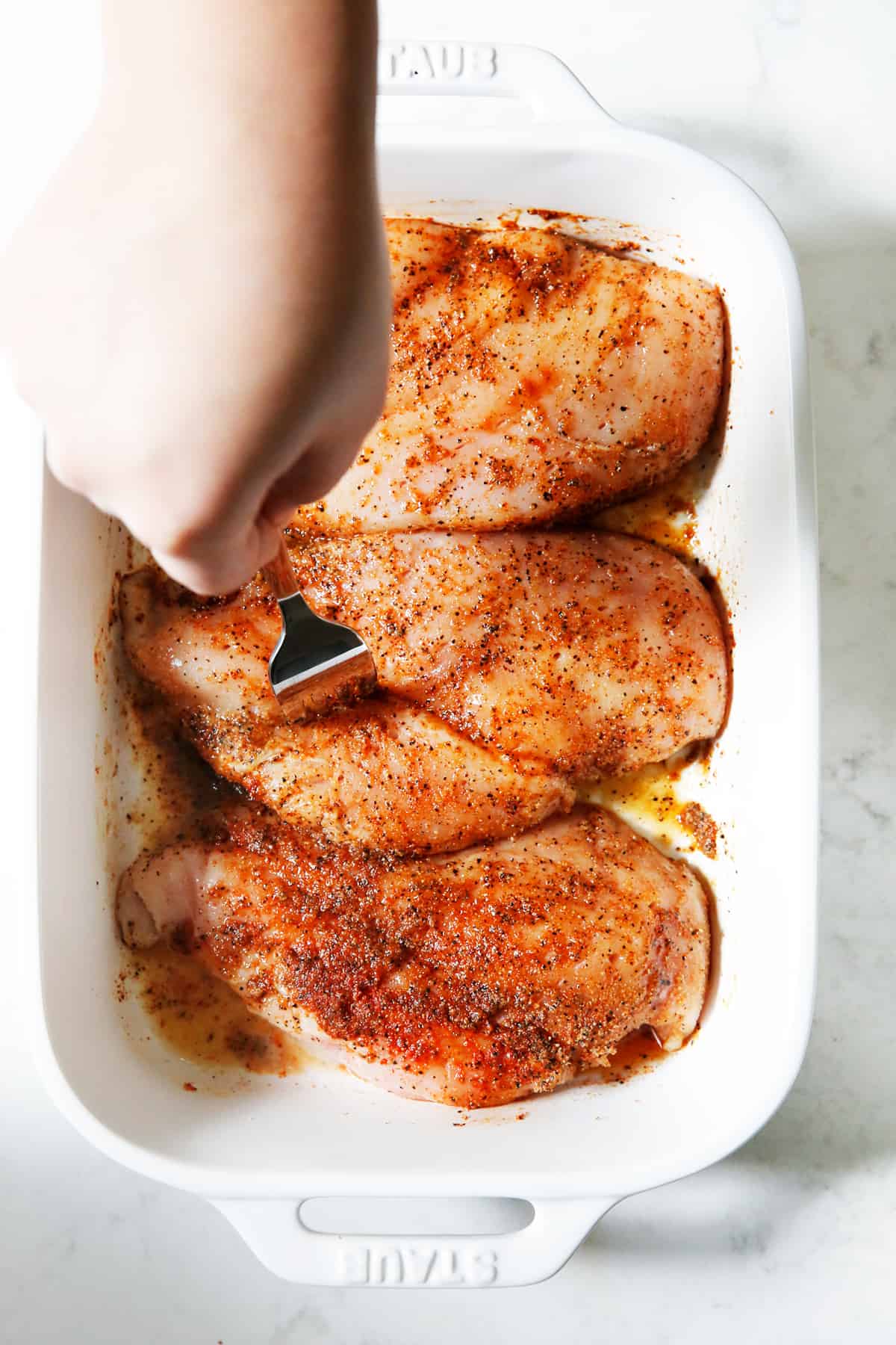 Piercing chicken breasts with a fork