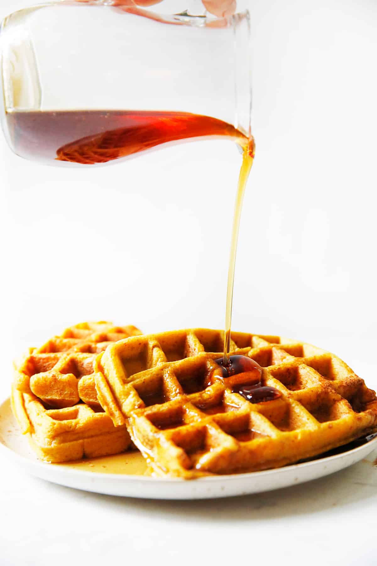 gluten free pumpkin waffles with maple syrup.