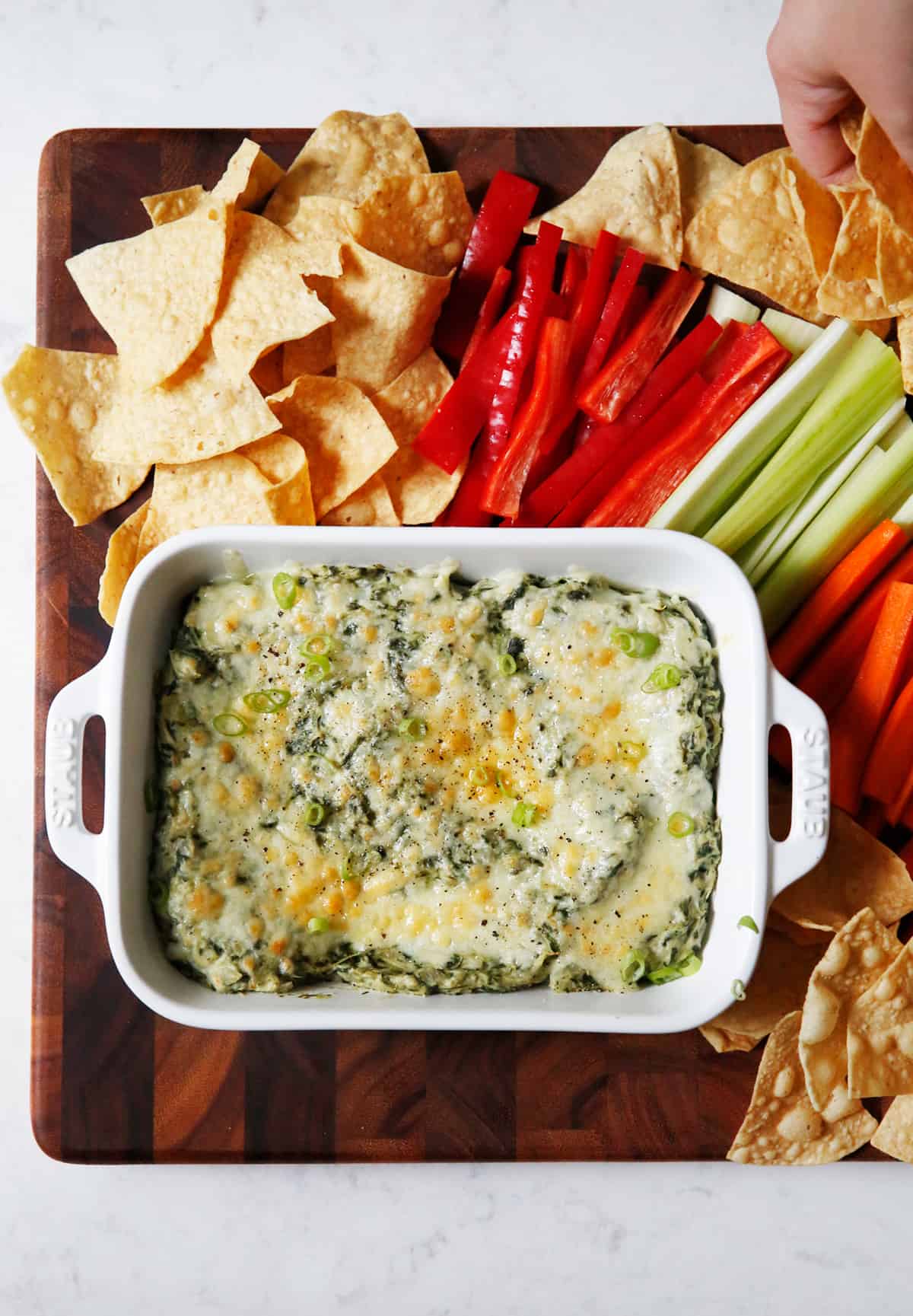 Healthy spinach dip with chips and veggies.