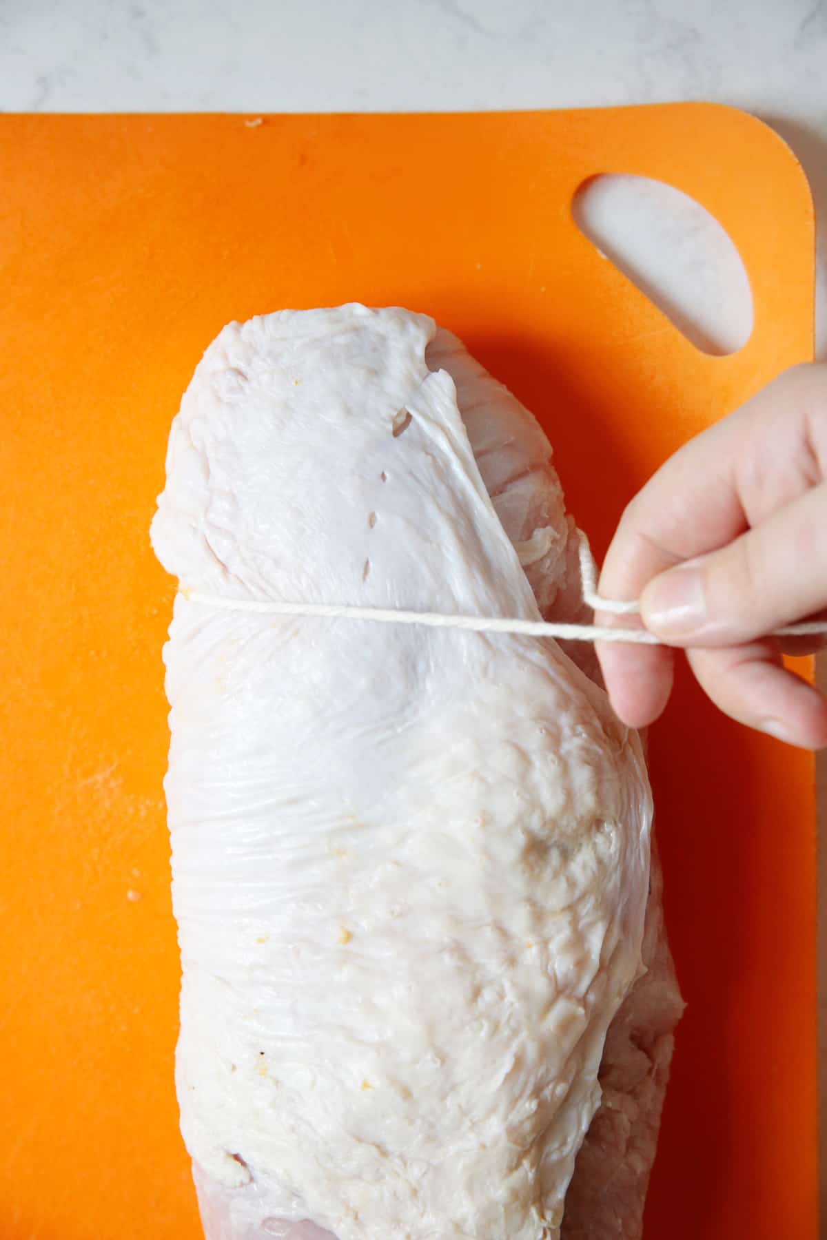 Trying up a stuffed turkey breast with butcher's twine