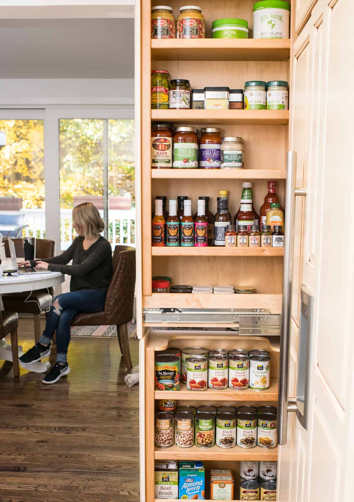 A well stocked pantry with the doors open.