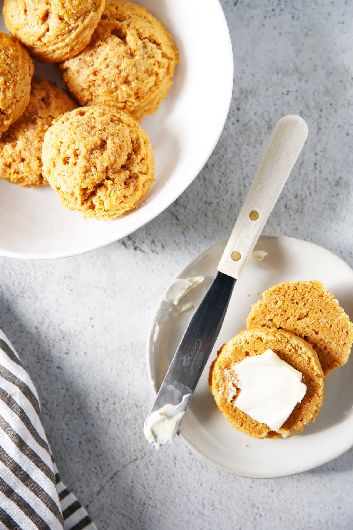 Pumpkin biscuits cut in half with butter.