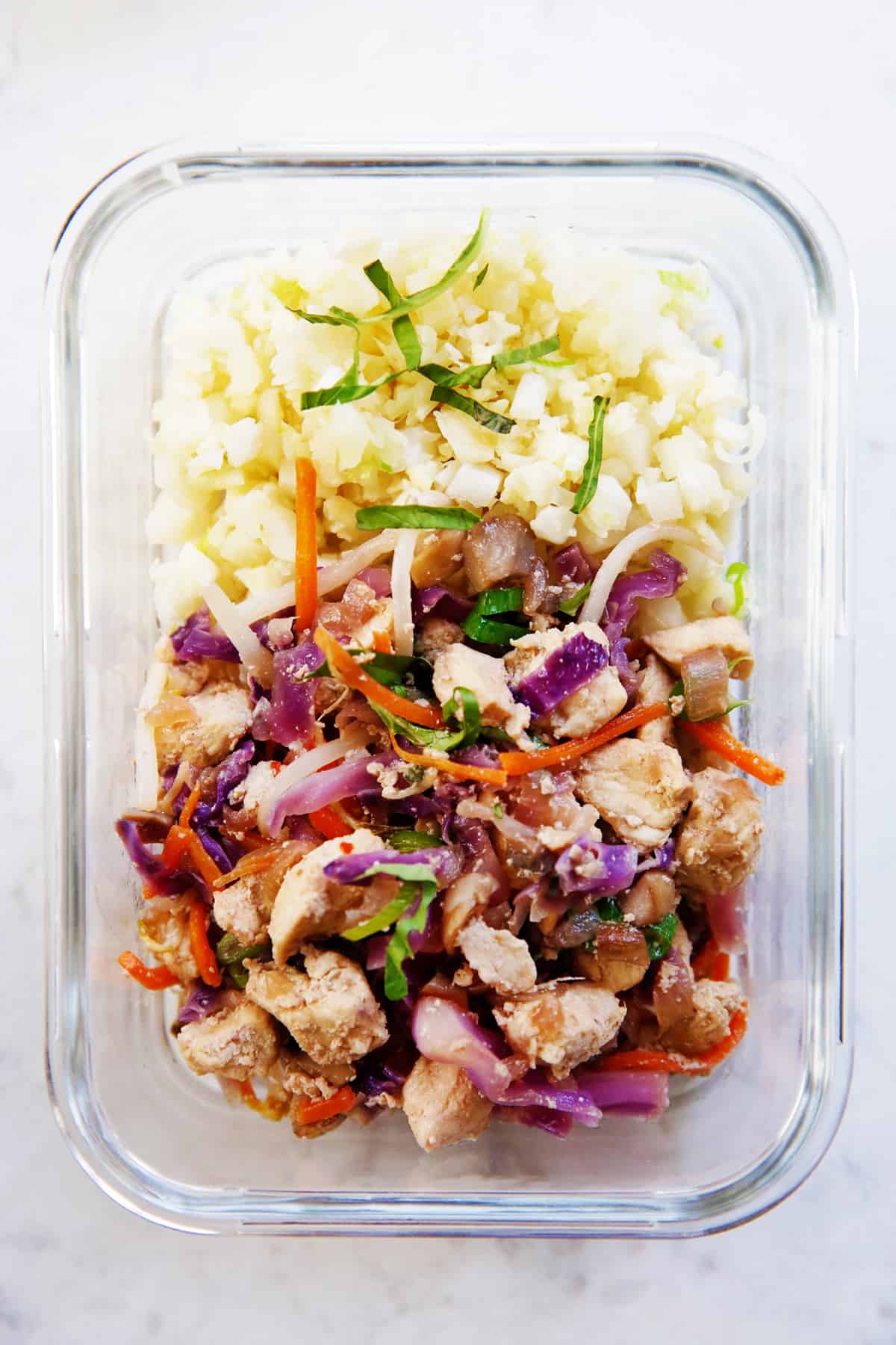 Thai chicken with cauliflower rice in a meal prep container.