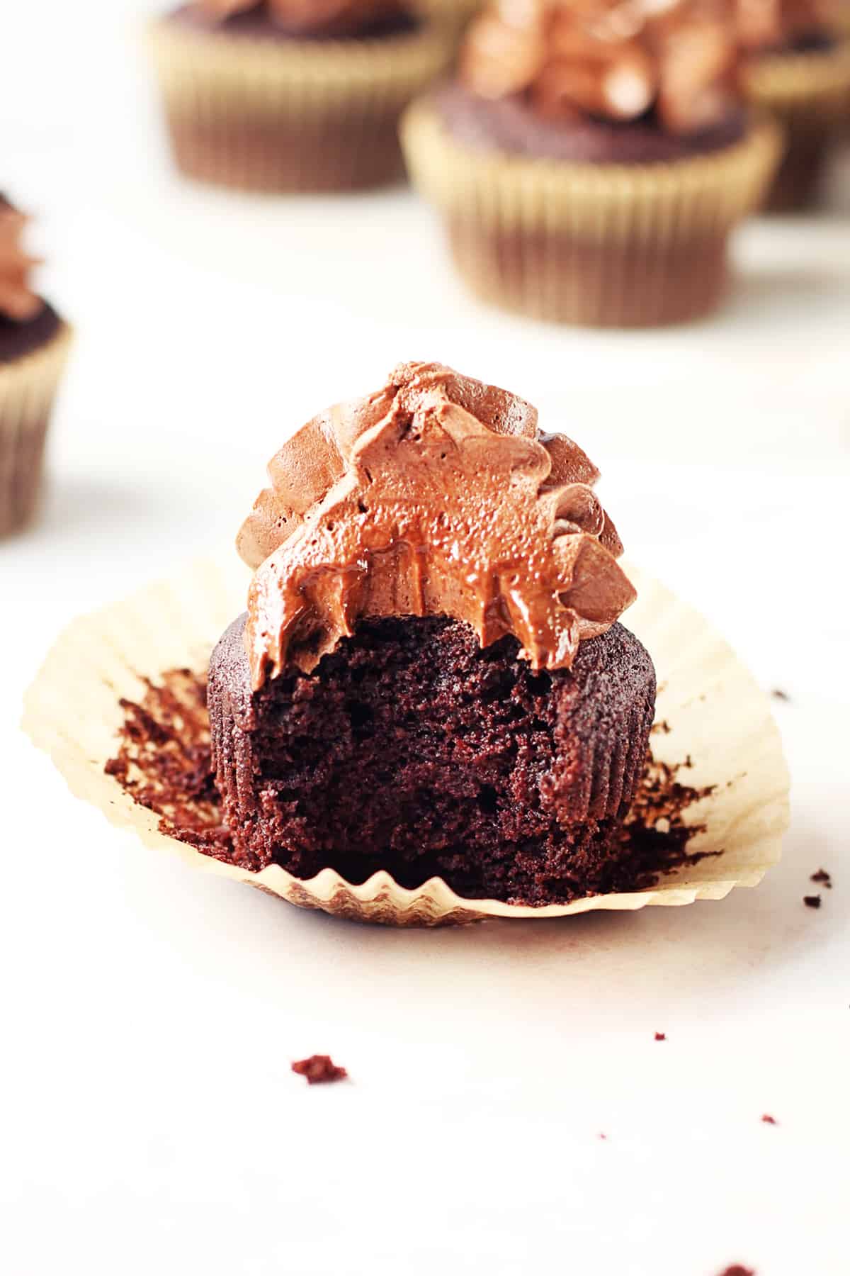 Paleo chocolate cupcake with a big bite taken out of it.