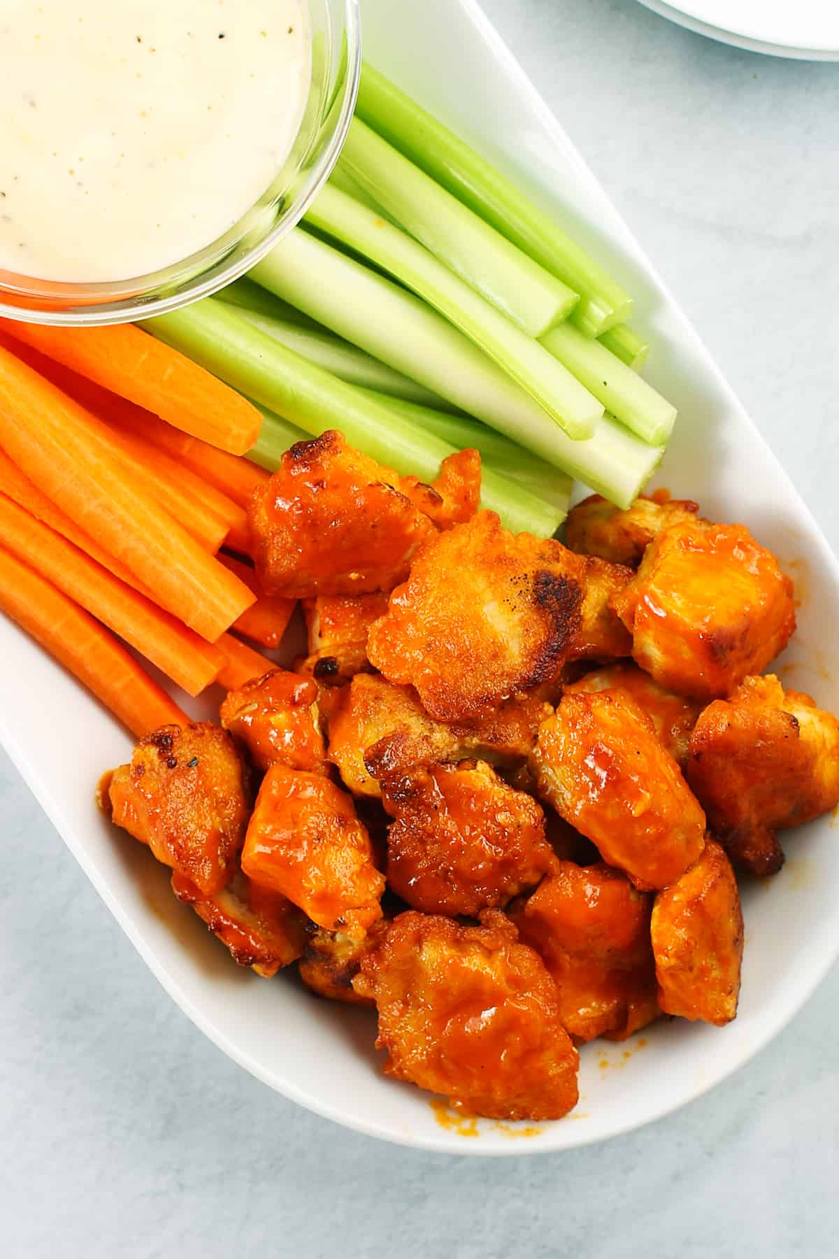 Buffalo bites with celery and carrots.