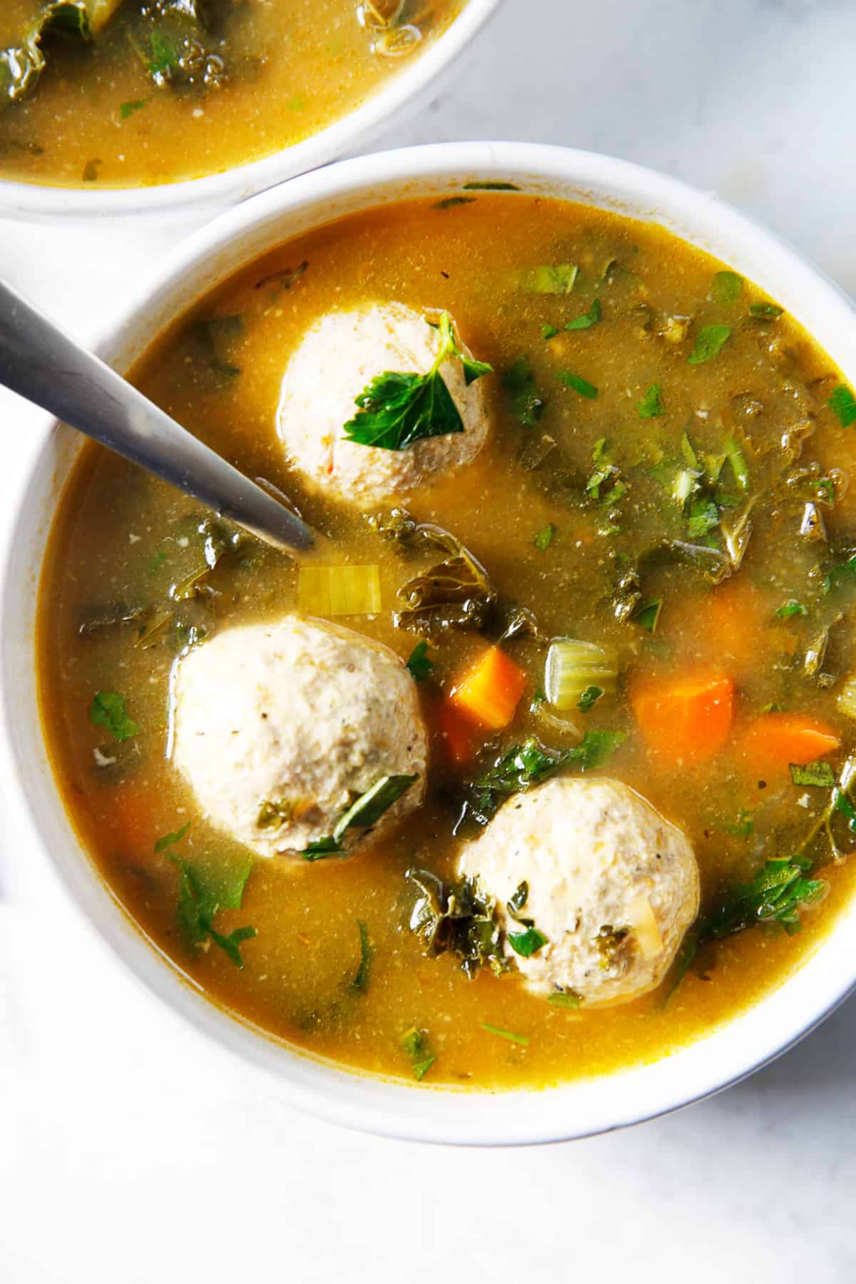A bowl of Italian wedding soup with ground turkey meatballs.