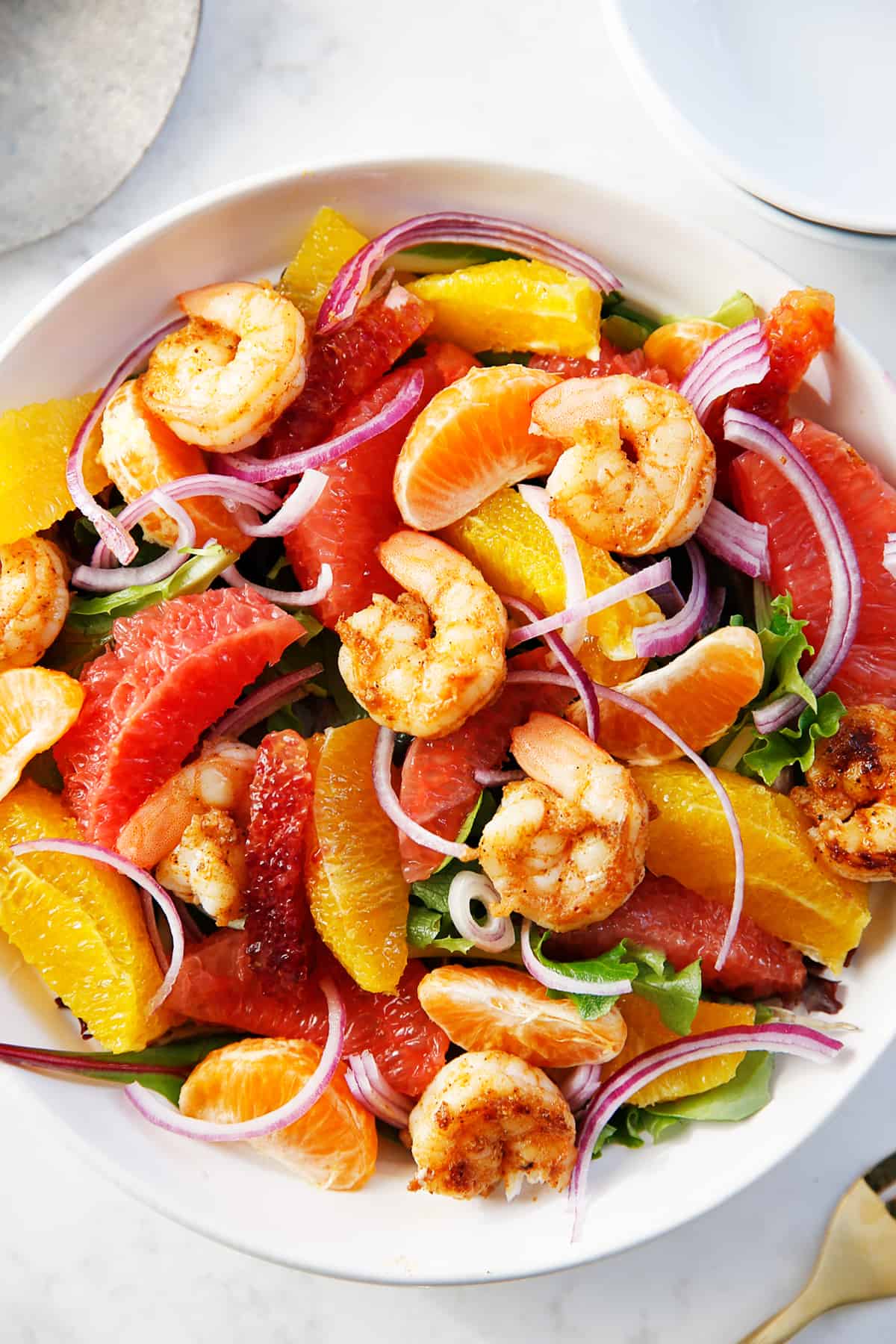 Spicy shrimp salad with citrus in a bowl.