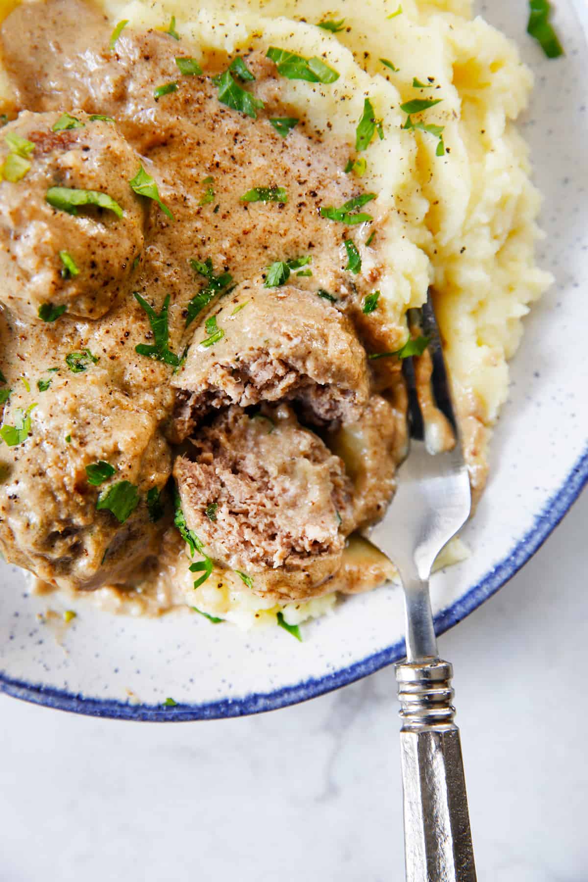 Gluten free Swedish Meatballs on a bed of mashed potatoes.