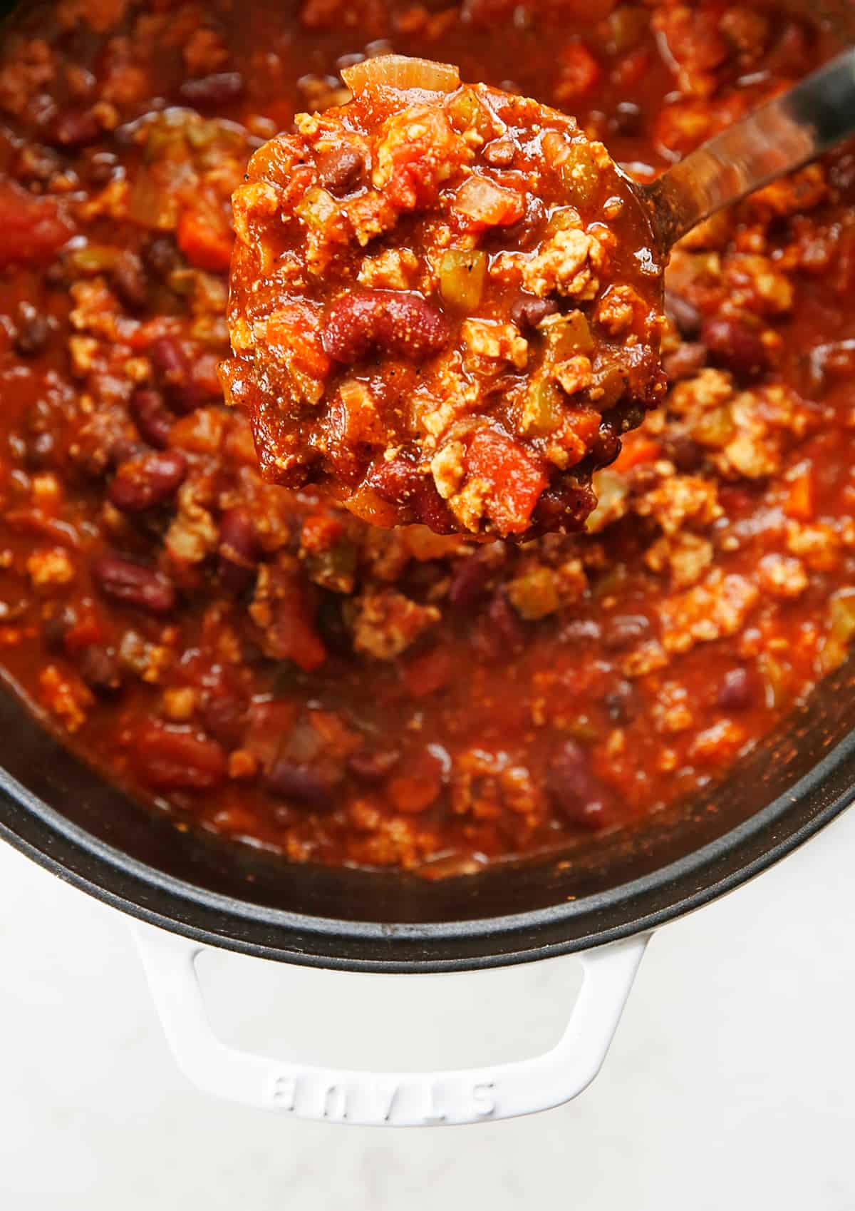 A ladle full of turkey chili.