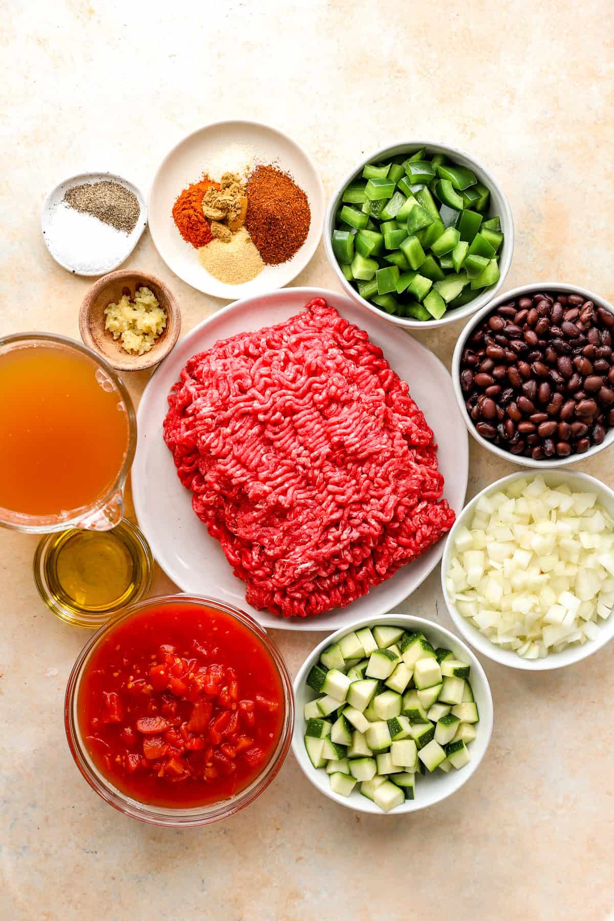 Bowls of filled with taco soup ingredients.