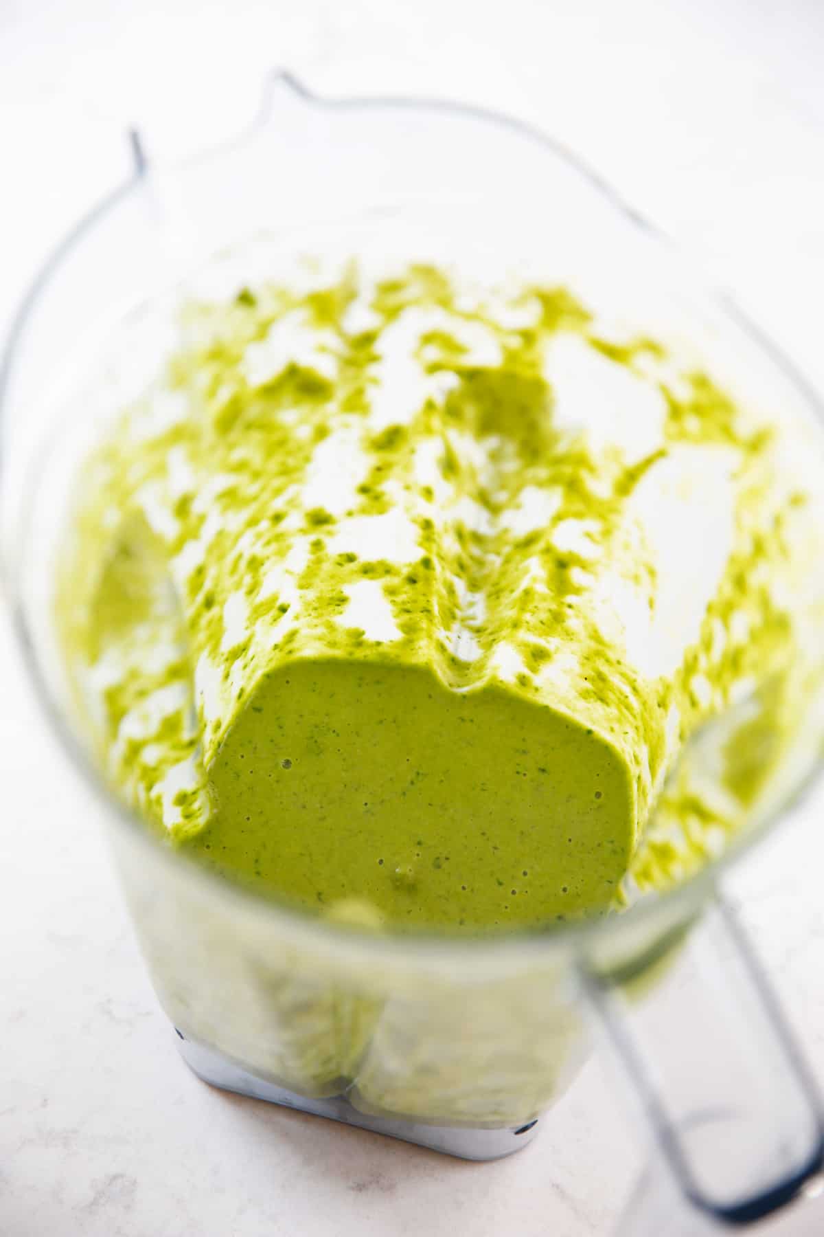 A blender with green pancake batter from spinach.
