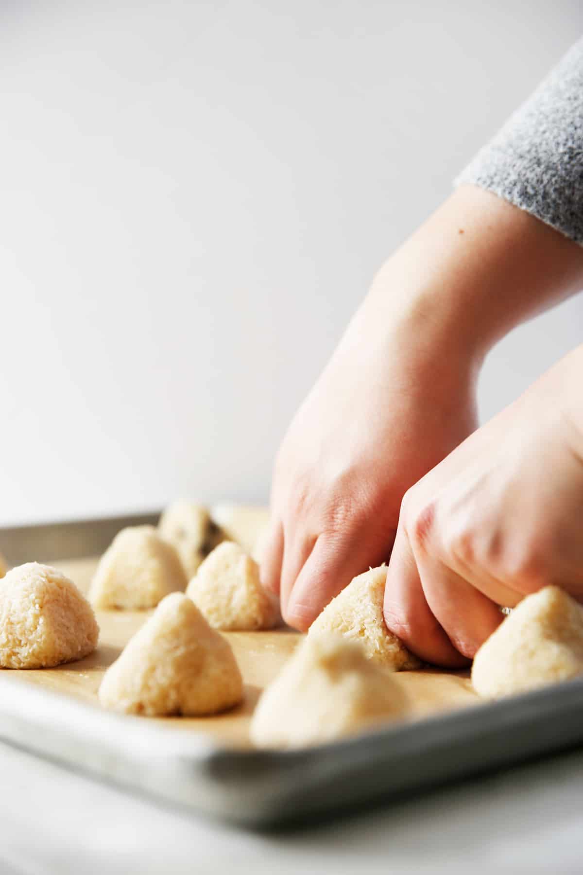 Pinching the tops for traditional passover coconut macaroons.