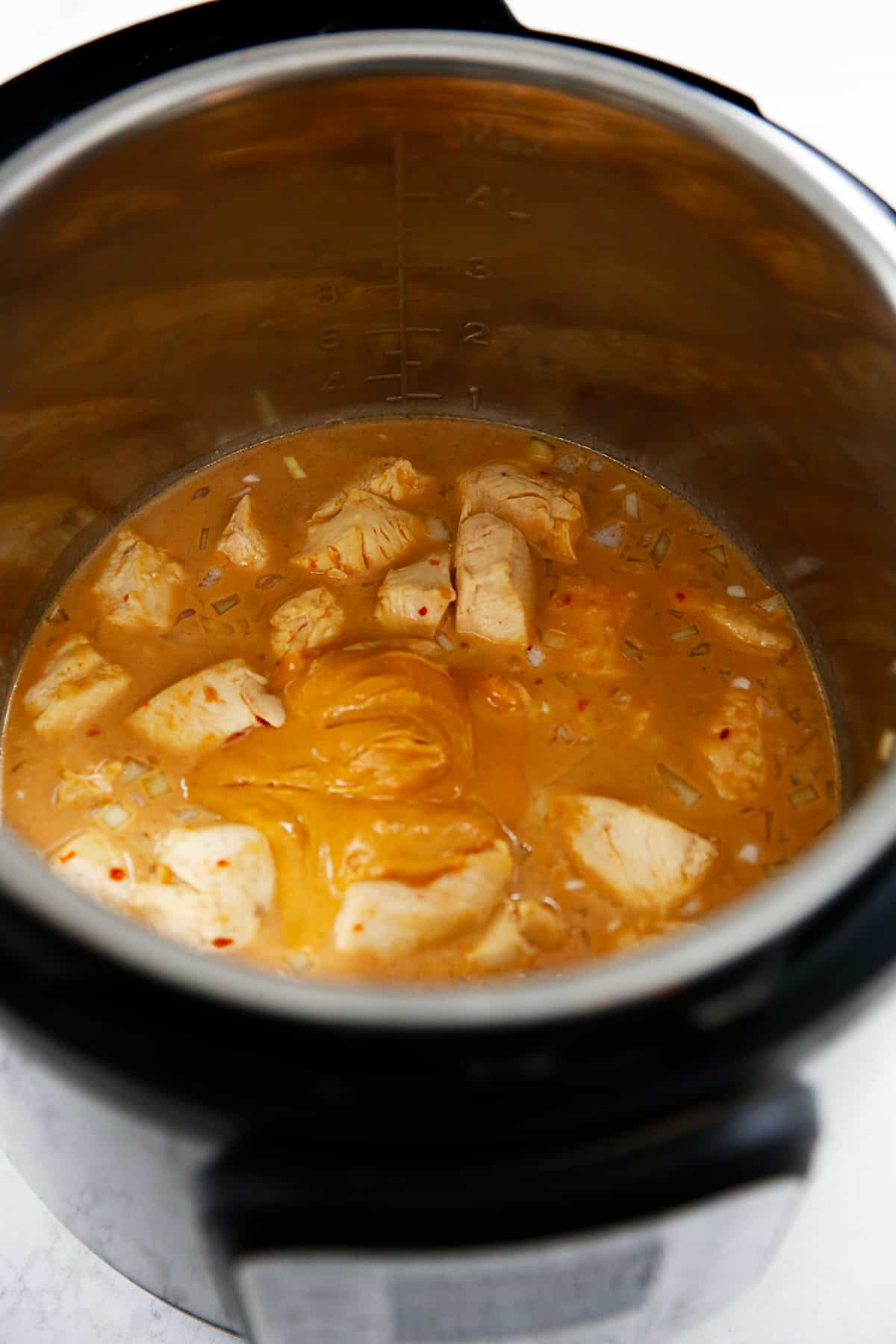 Peanut butter in the center of the instant pot to make Thai peanut chicken.