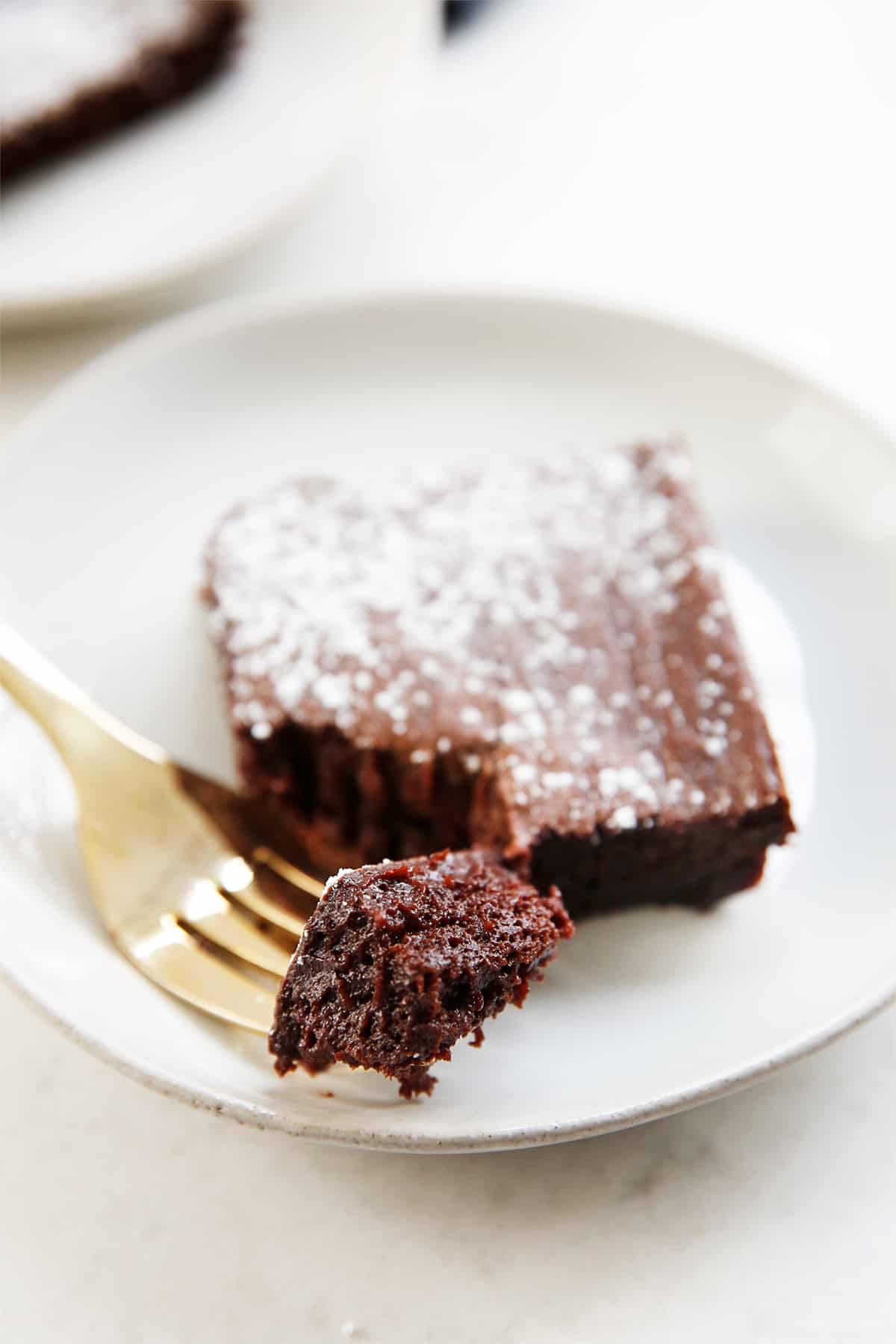 a bite of a healthy brownie on a fork with the brownie.