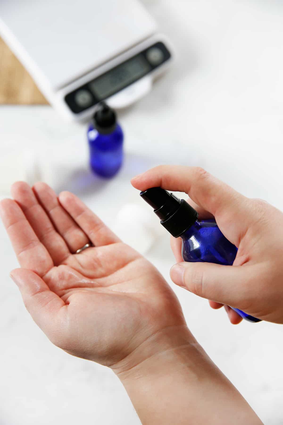 Spraying a bottle of homemade hand sanitizer