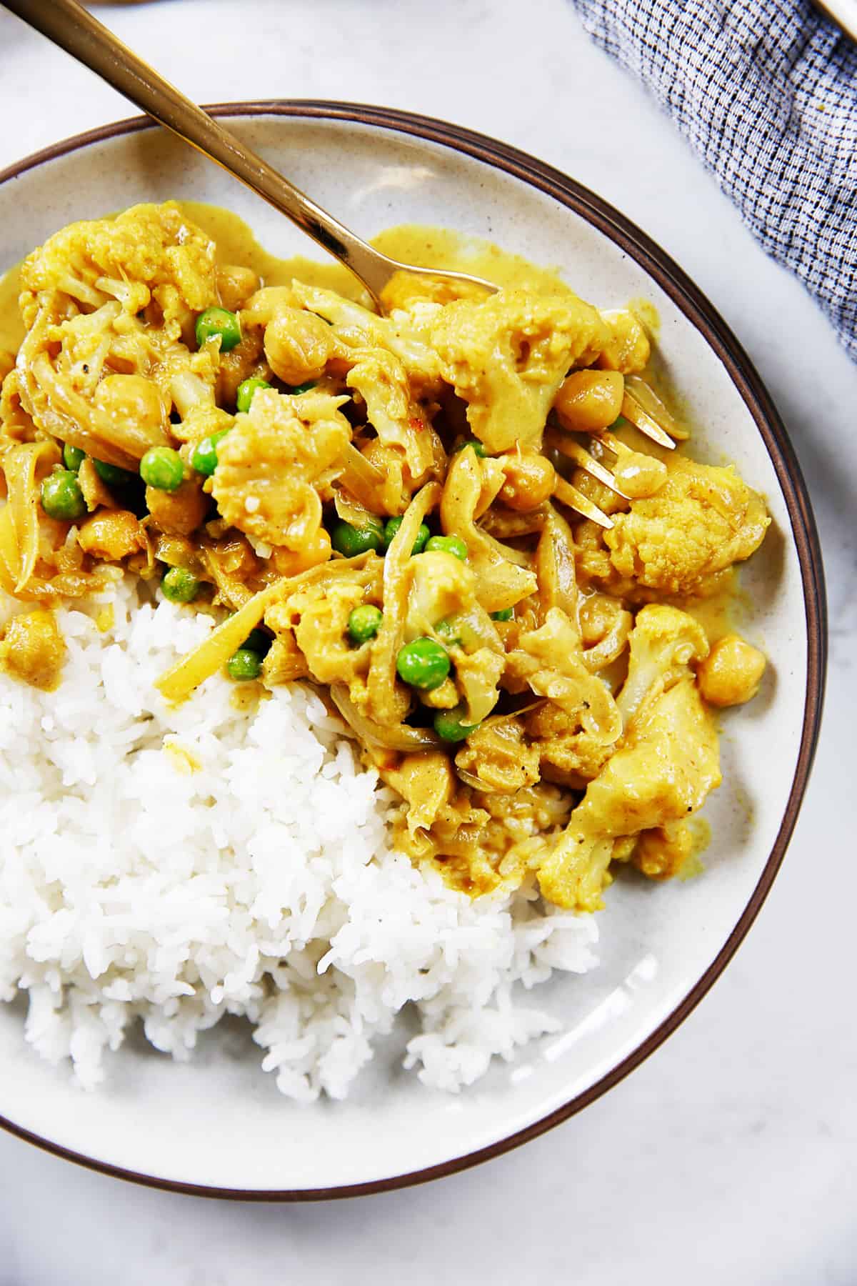 Vegan cauliflower curry with rice on a plate.