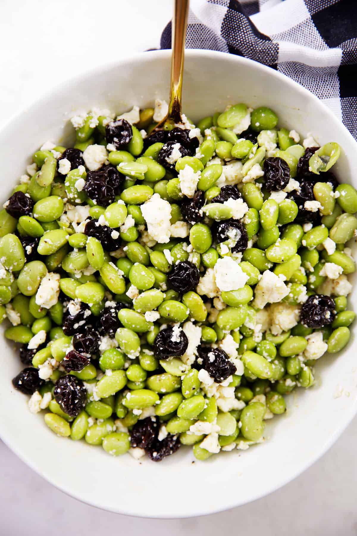 A bowl filled with an edamame salad.