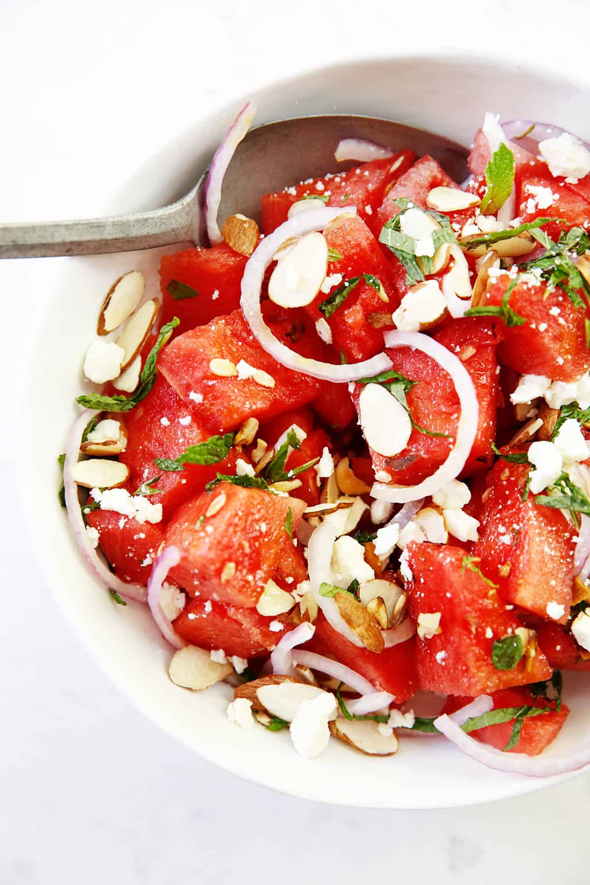 Watermelon salad with sliced onions and nuts