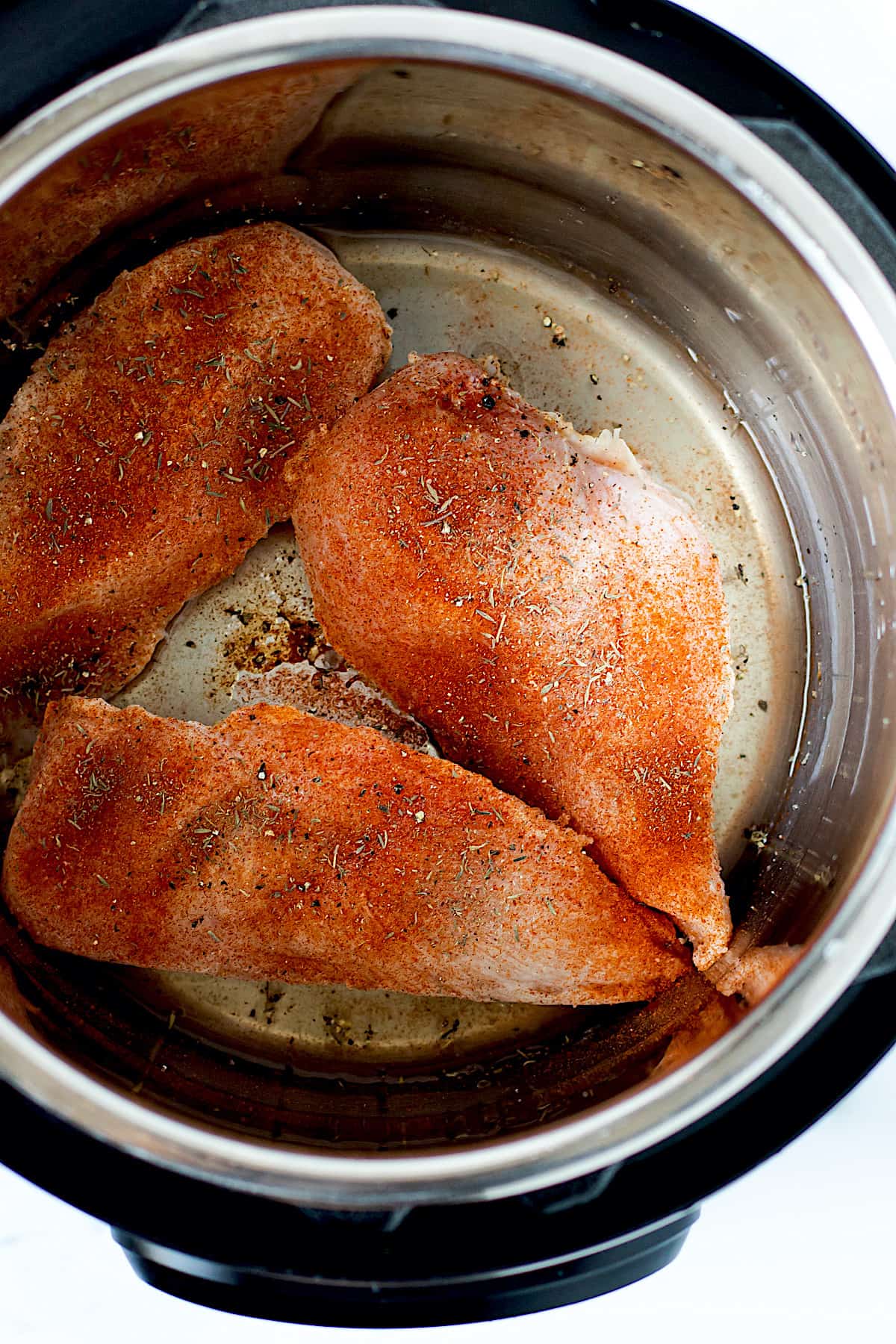Raw frozen chicken breasts in the Instant Pot