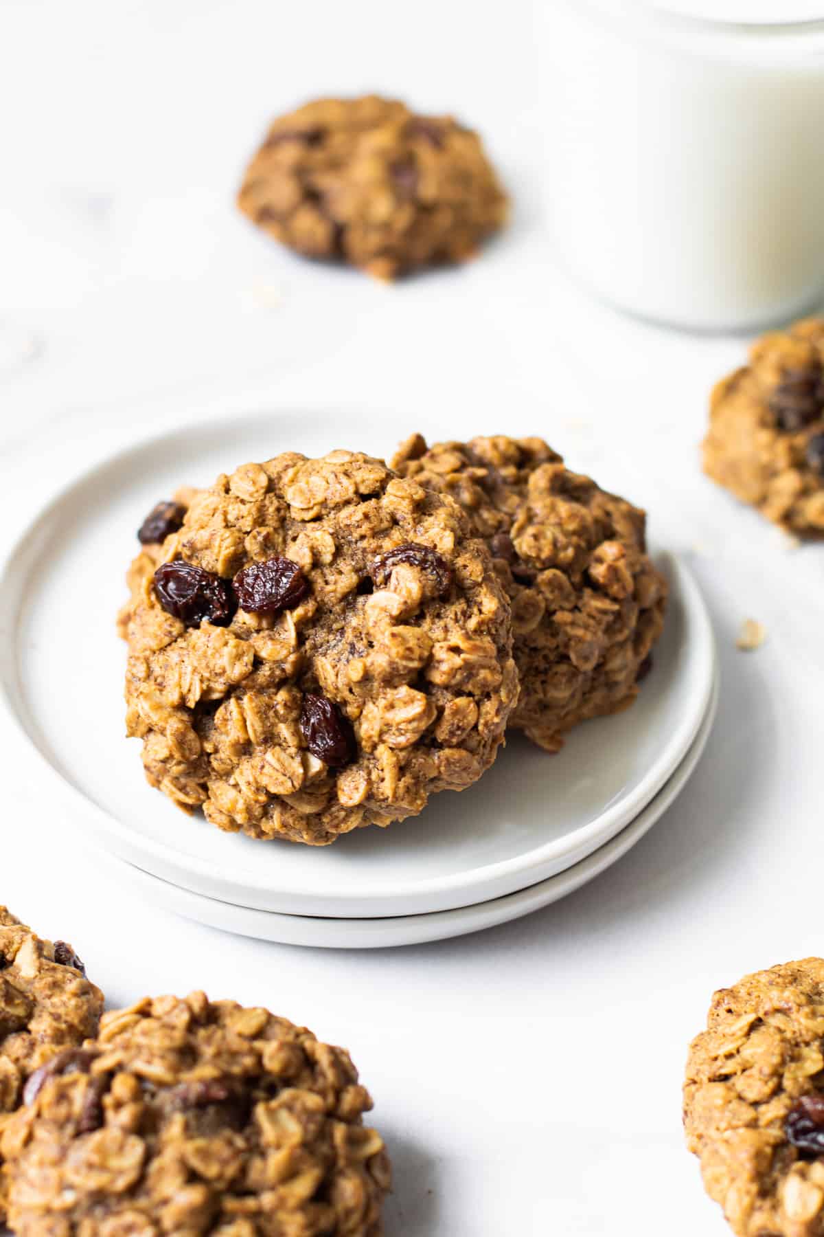 Gluten free lactation cookies on a plate near a glass of milk.