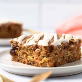 A piece of carrot zucchini bars on a plate.