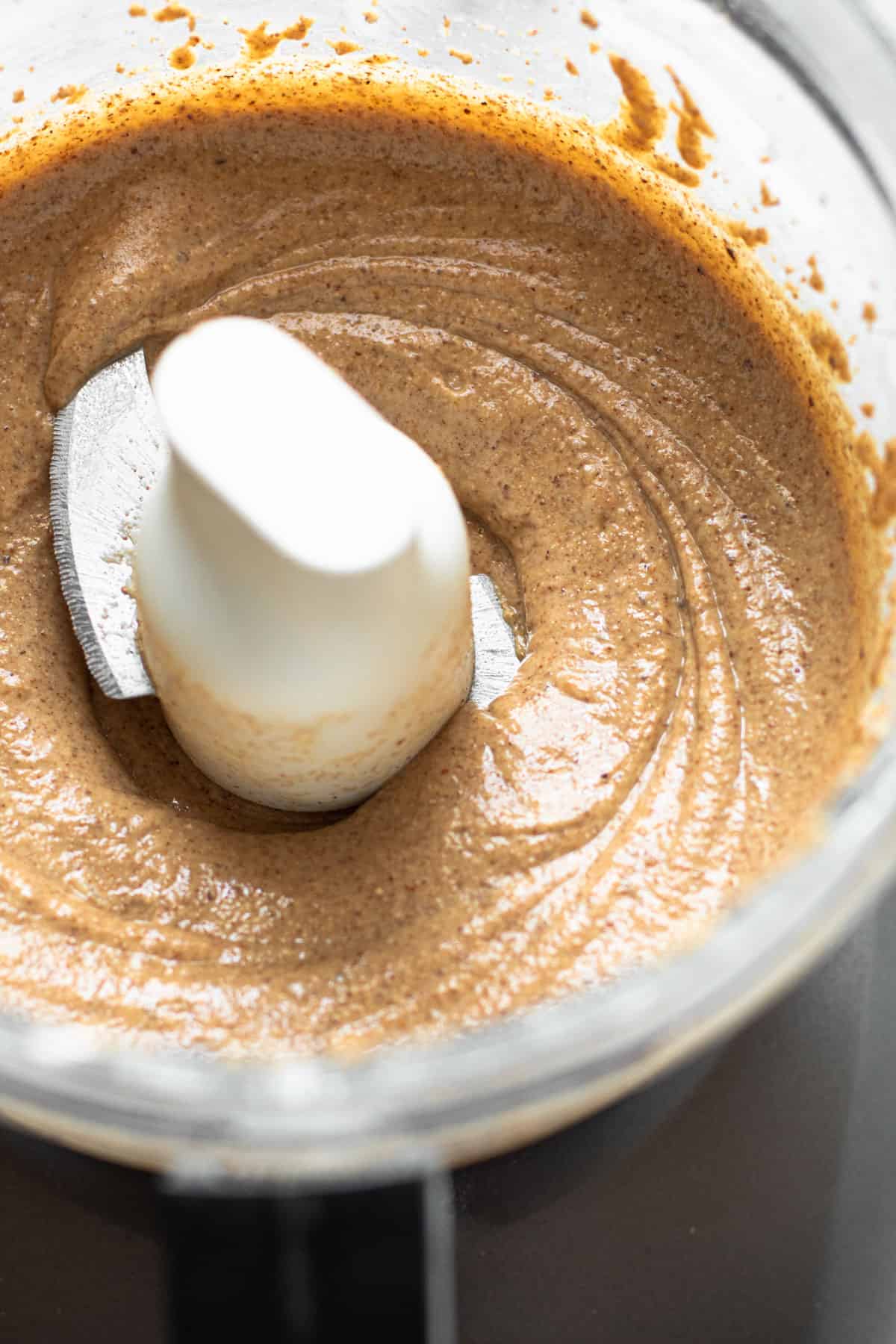 Creamy and thick homemade almond butter in a food processor.