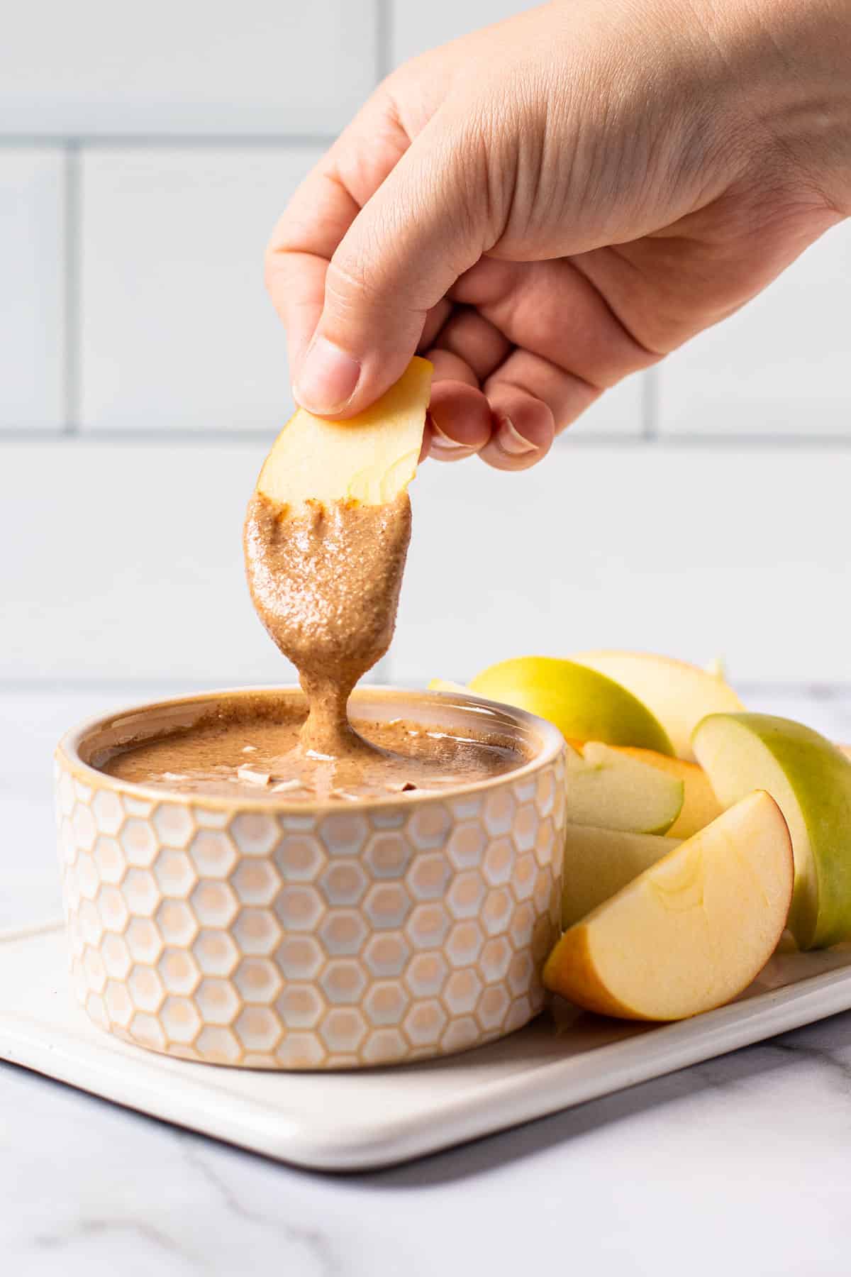 A dipped apple in almond butter.