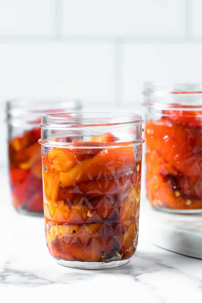 Roasted red peppers in three jars.