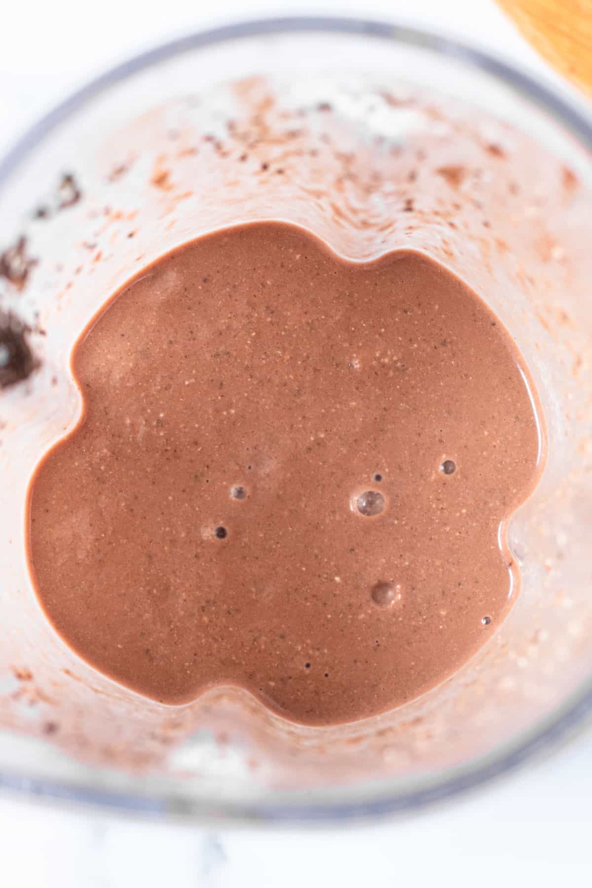 Chocolate coconut smoothie blended up in a blender.