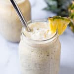 Pina colada smoothie with a pineapple garnish.