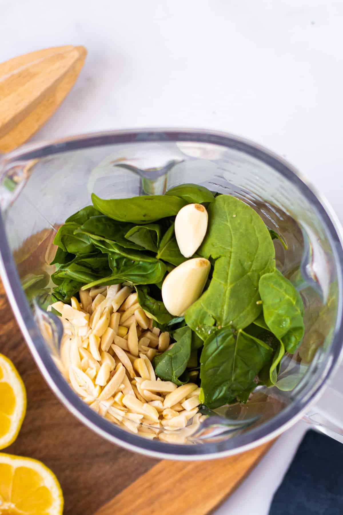 Ingredients for spinach basil pesto in a food processor.