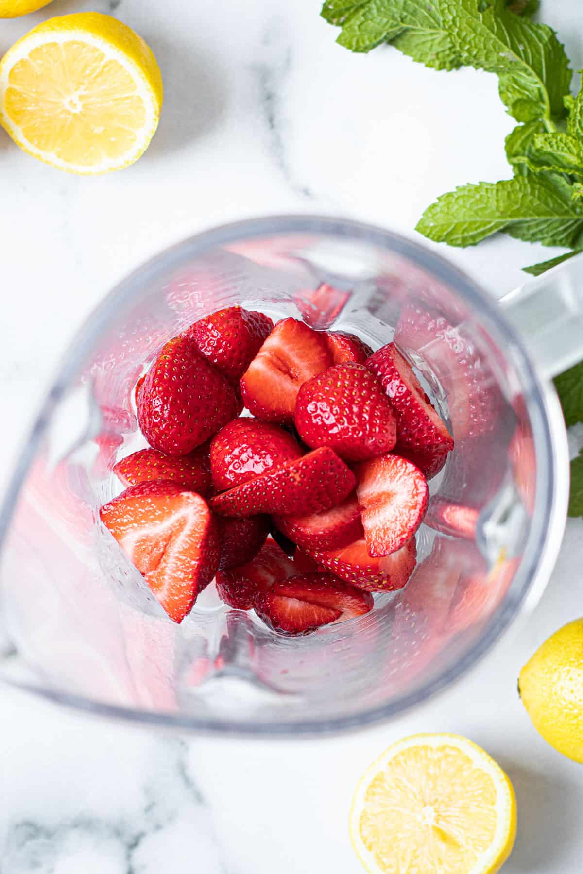 Strawberries in a blender to make strawberry lemonade.