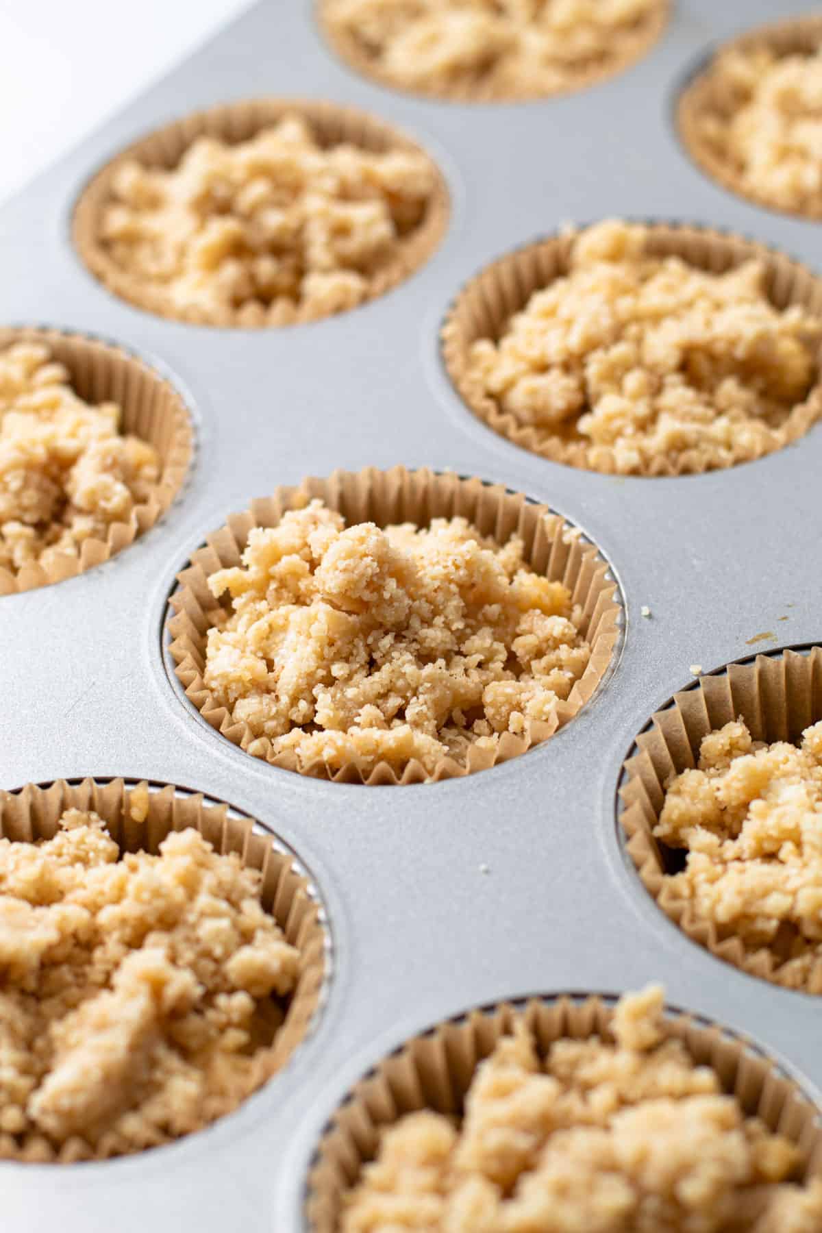 Gluten Free Coffee Cake Muffins before being baked in a muffin tin.
