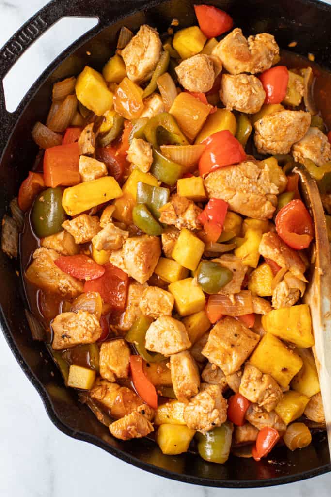 Pineapple chicken in a skillet.