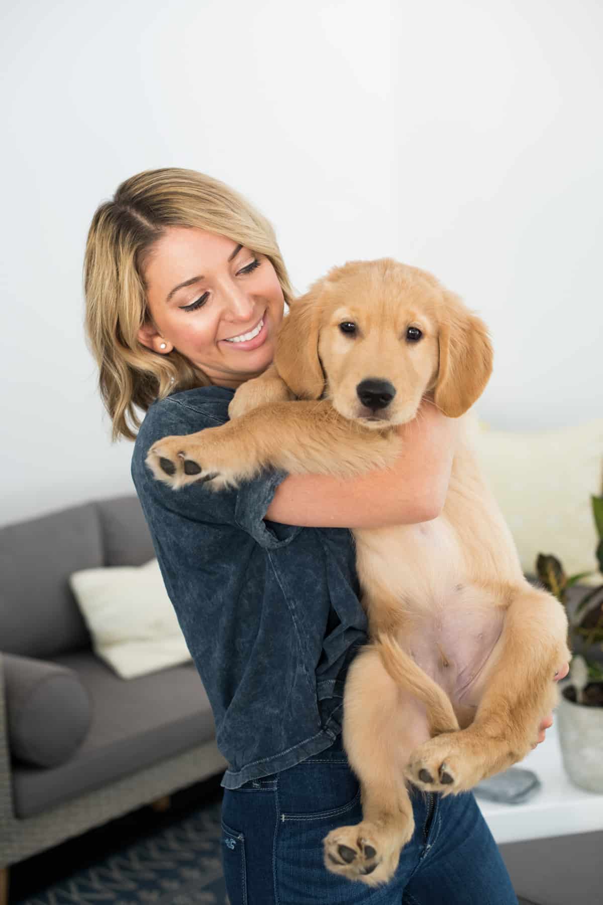 Woman holding a puppy that needed pet insurance.