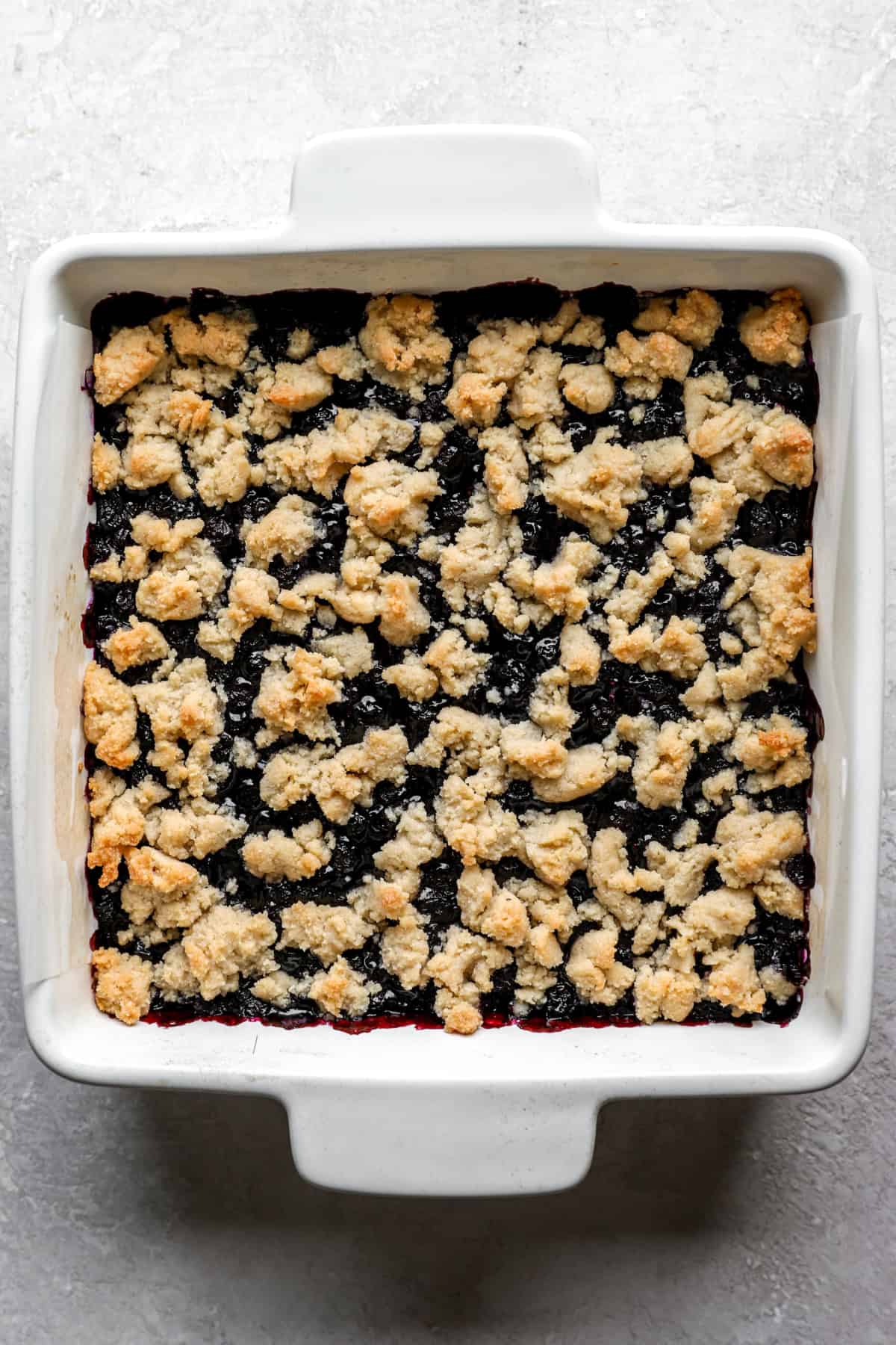 Blueberry crumb bars in a square baking dish. 
